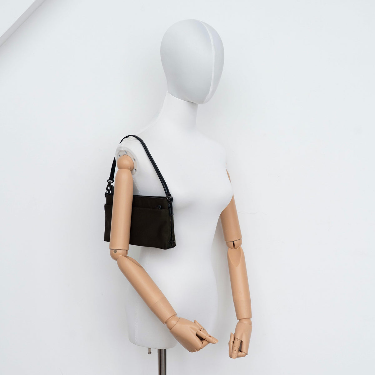 Coach Mercer Demi Tote Bag in brown nylon with black leather trim and gunmetal hardware, shown with signature Coach tag.