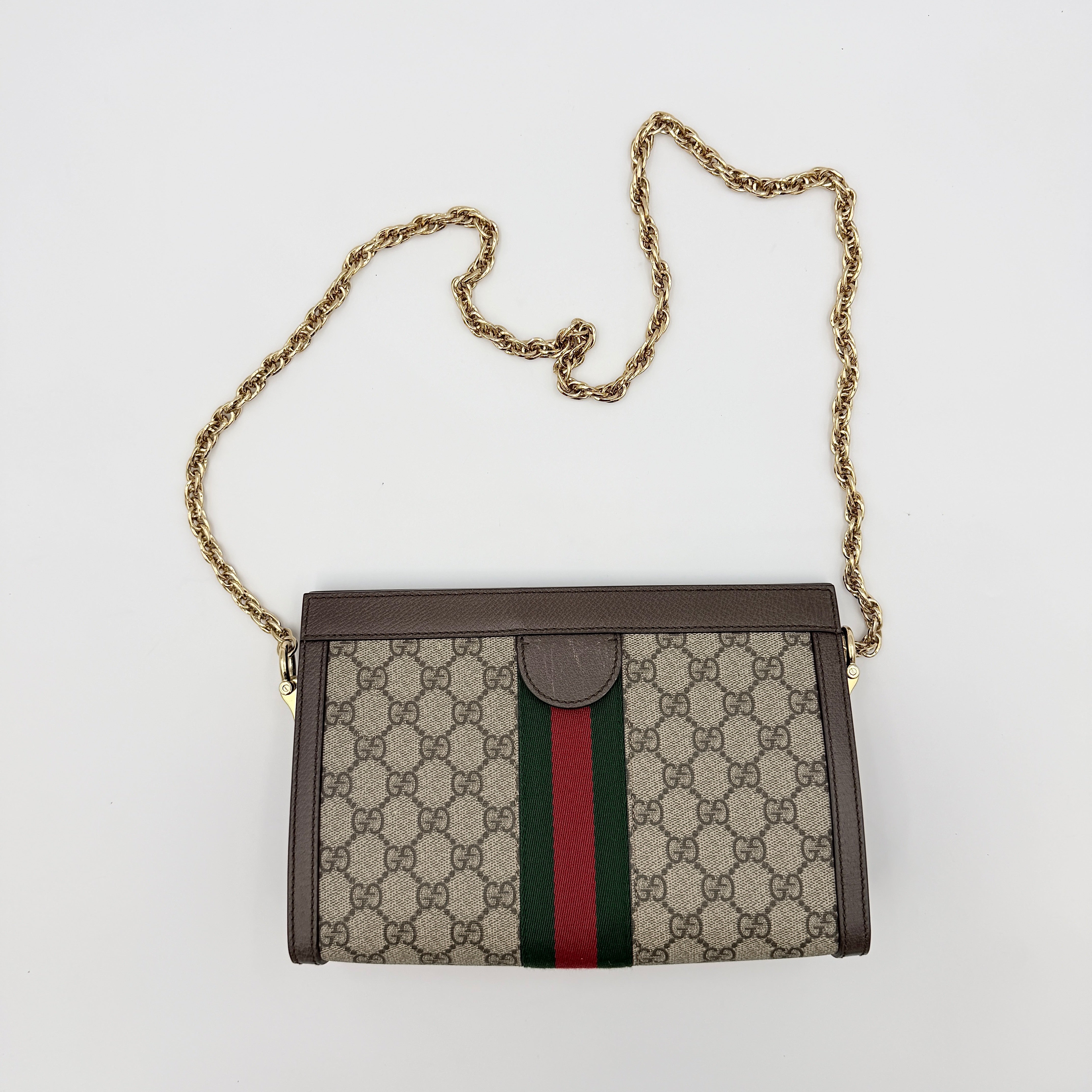 Gucci Ophidia GG Supreme crossbody bag in beige canvas with brown leather trim, signature web stripe, and gold chain strap.