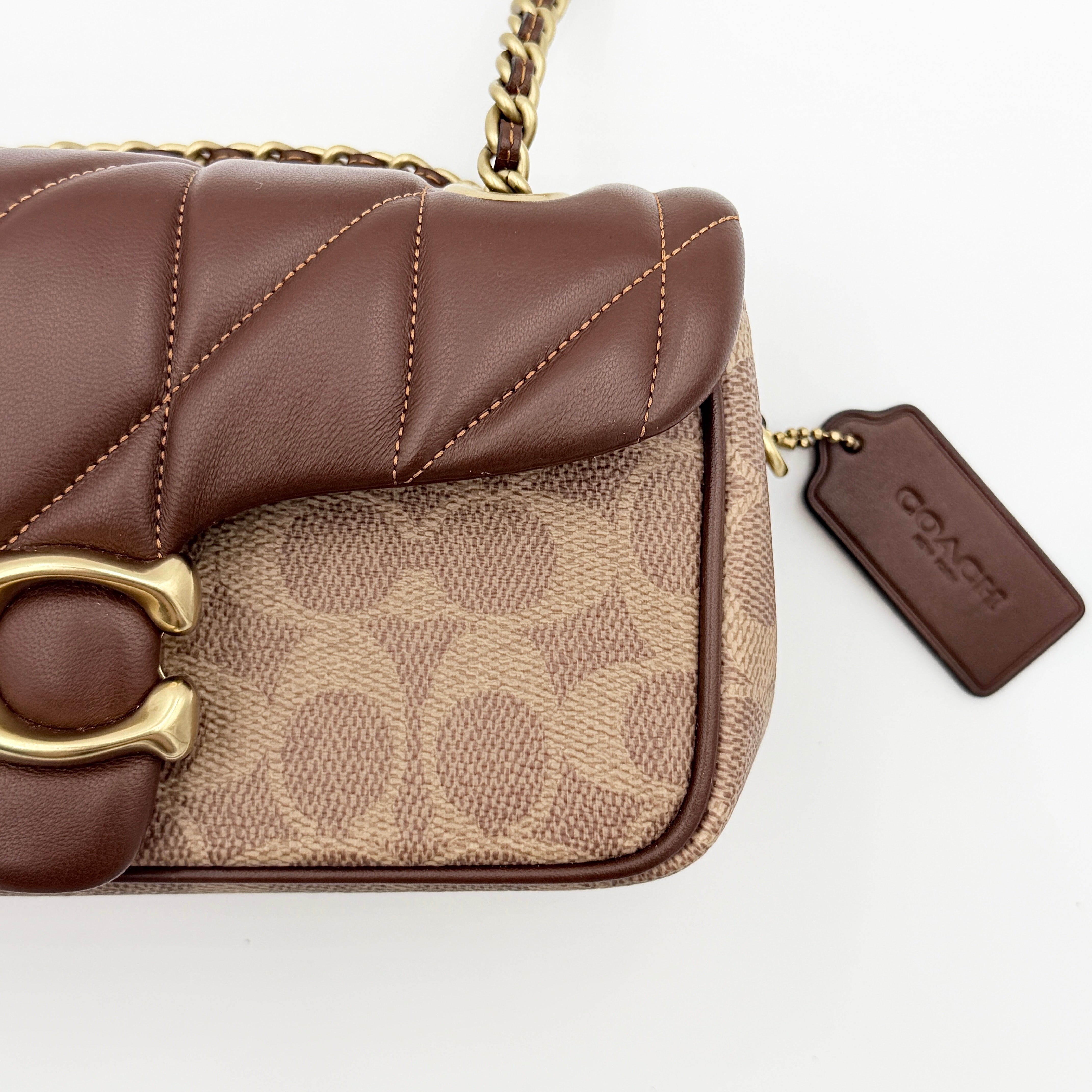 Coach Signature Quilted Tabby Shoulder Bag in brown monogram canvas with gold chain strap and oversized C clasp.