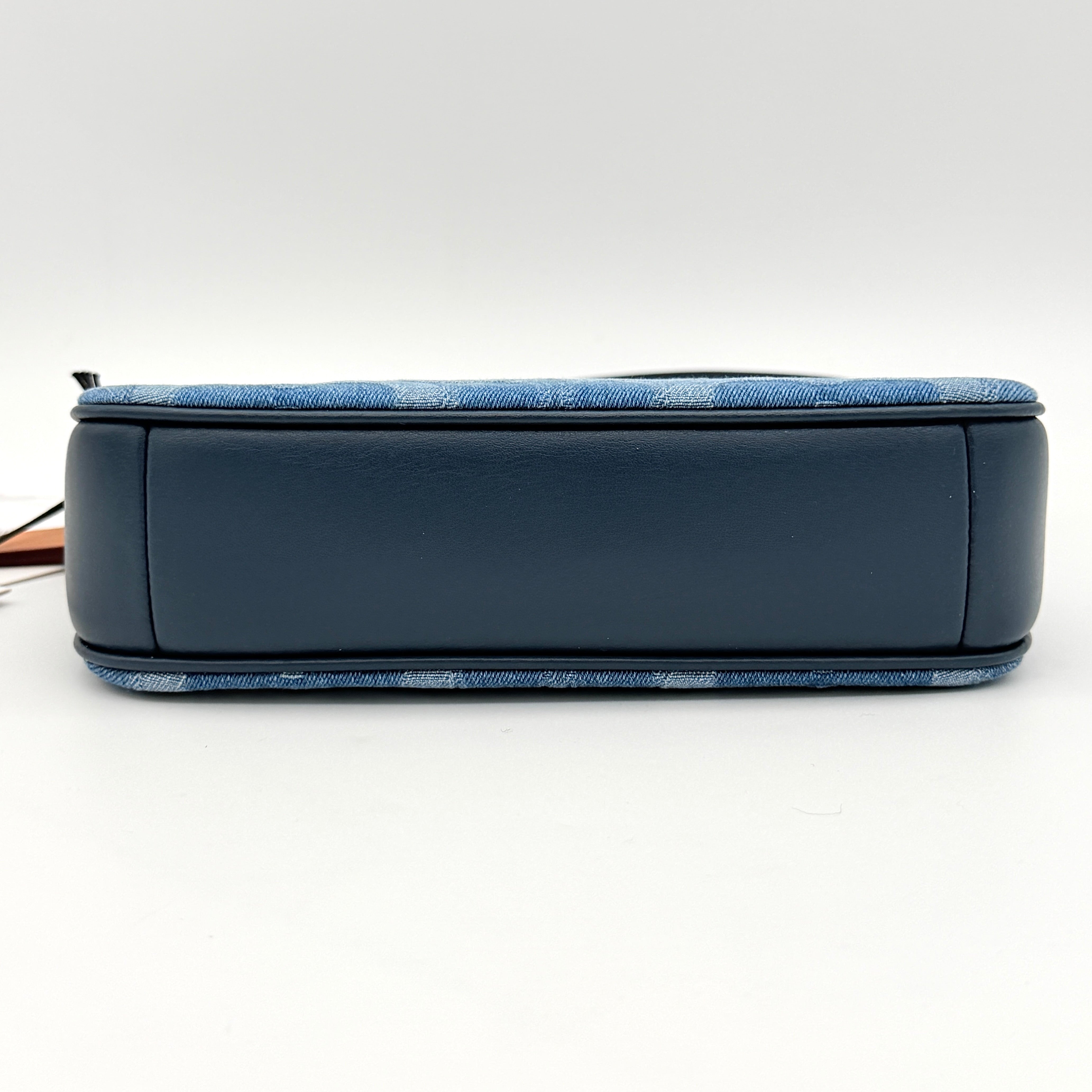 Coach Nolita 19 shoulder bag in blue denim jacquard with monogram print and gold hardware, shown with original packaging.