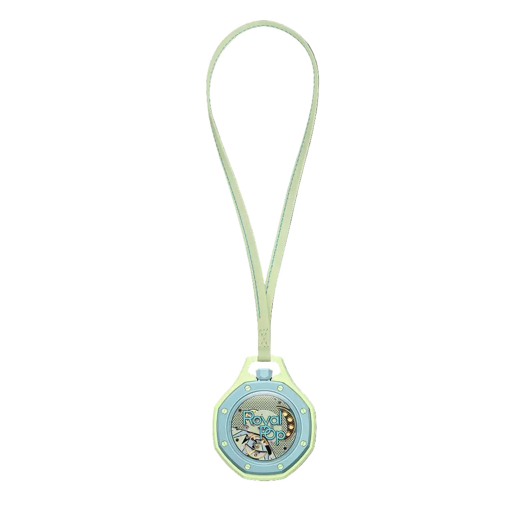 Swatch x Audemars Piguet Royal Pop Blaue Acht pendant watch in pastel green and blue, shown suspended on a matching strap.