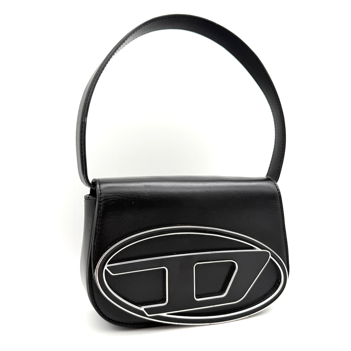 Diesel 1DR Shoulder Bag in black leather with a bold silver and black D logo plaque on the front flap.