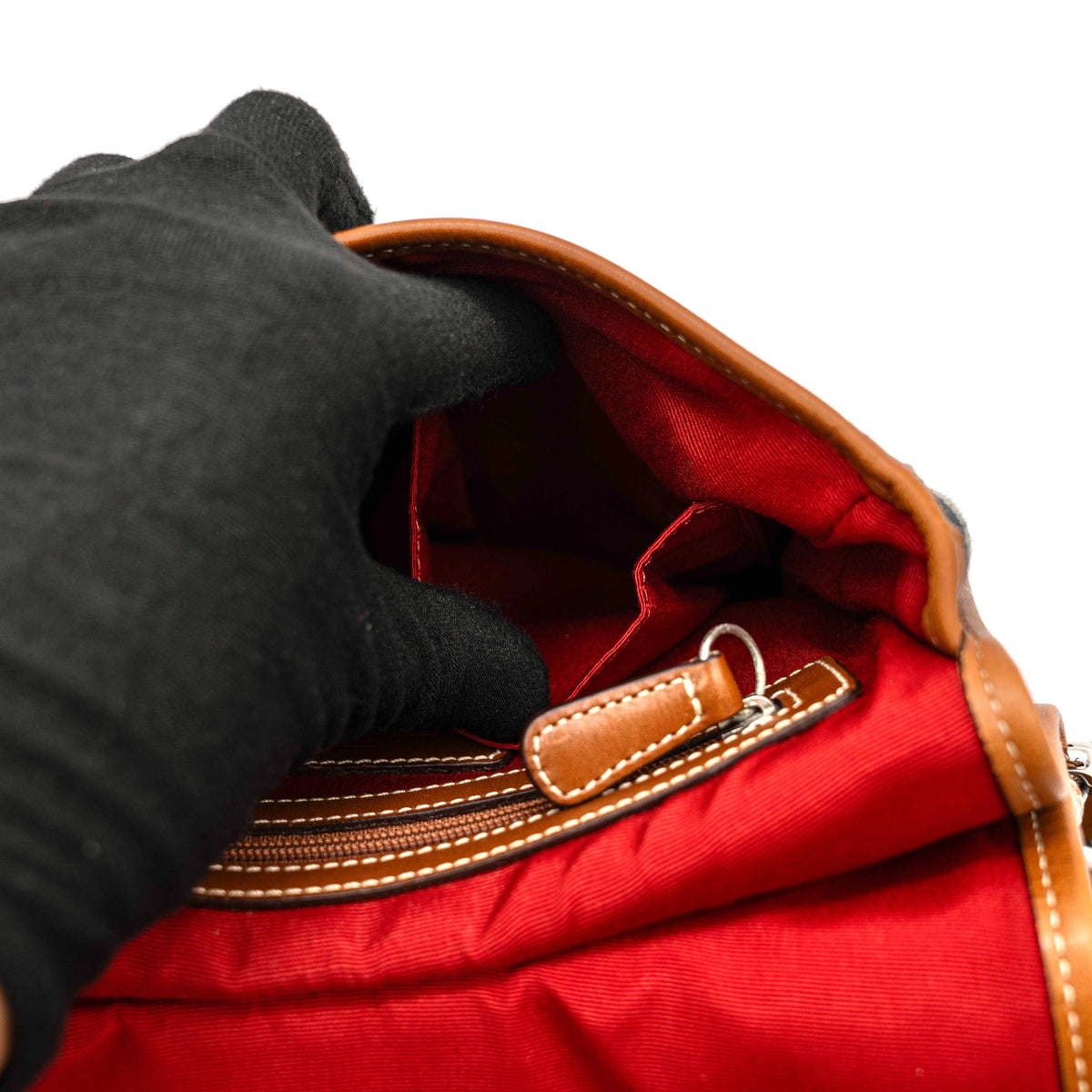 Coach signature denim hobo crossbody bag with red and blue stripe, brown leather trim, and an adjustable strap.
