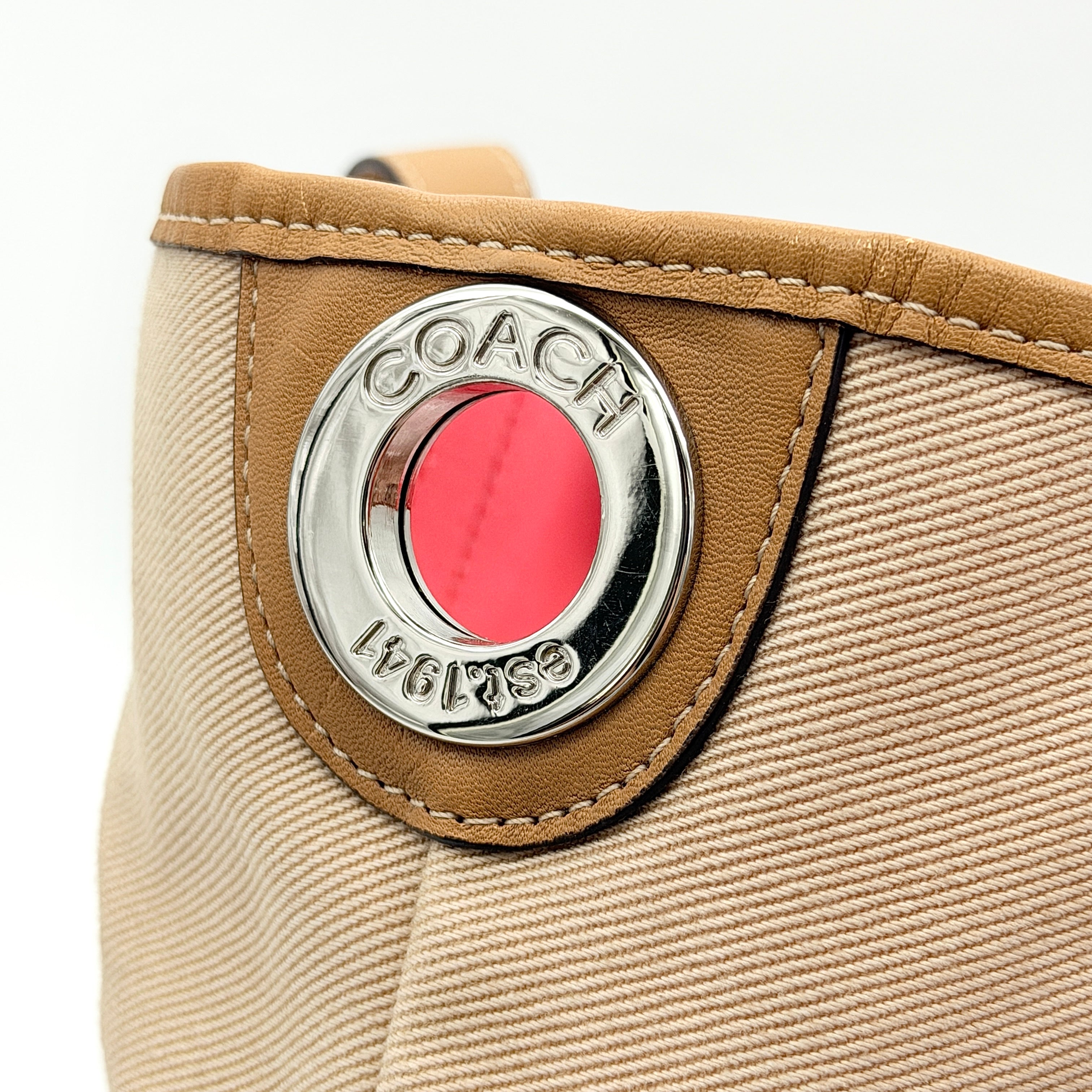 Coach Hadley Variegated Stripe Handbag in beige and tan canvas with leather trim, shown with top handles and detachable strap.