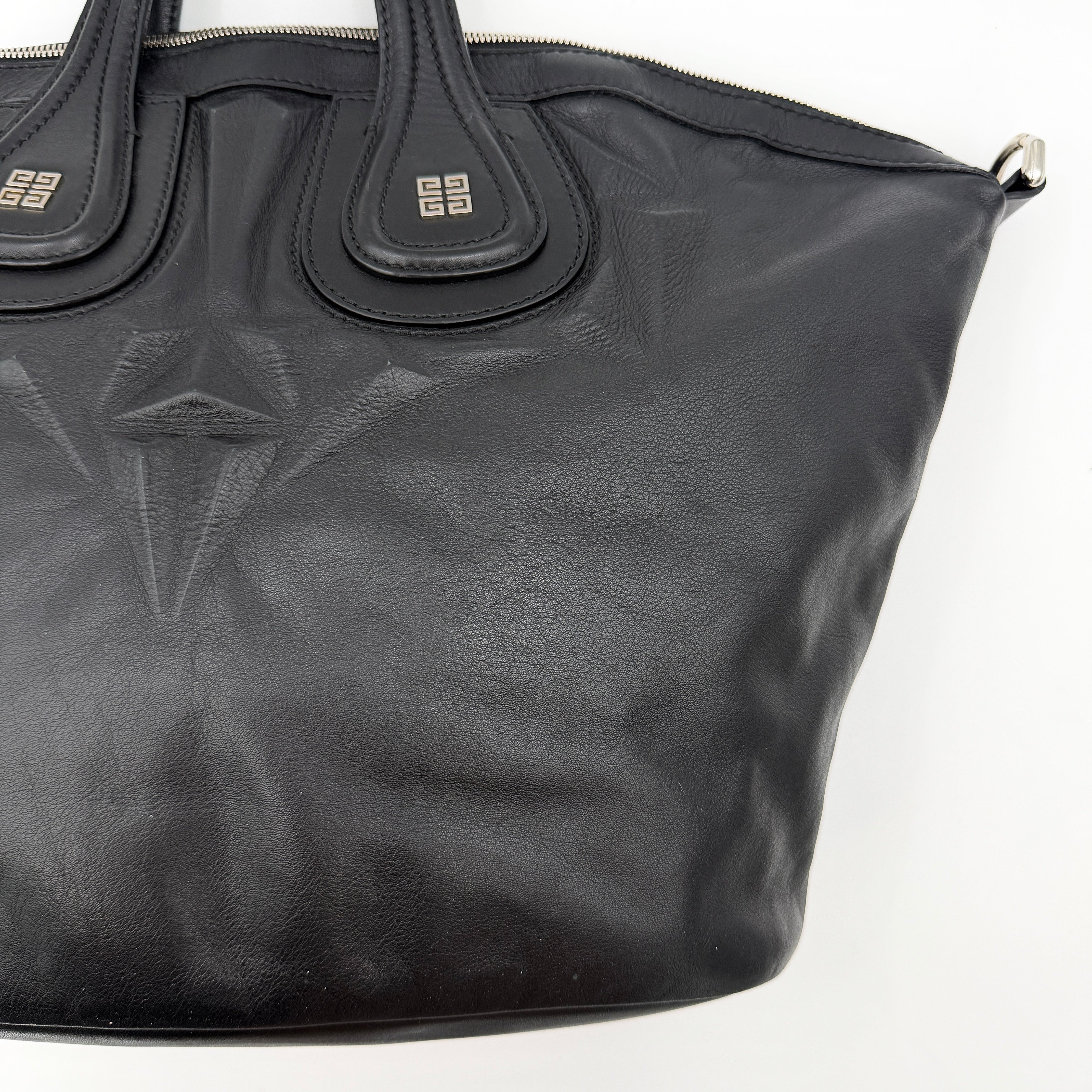 Givenchy 2Way Nightingale Handbag in black leather with detachable strap and striking front motif.