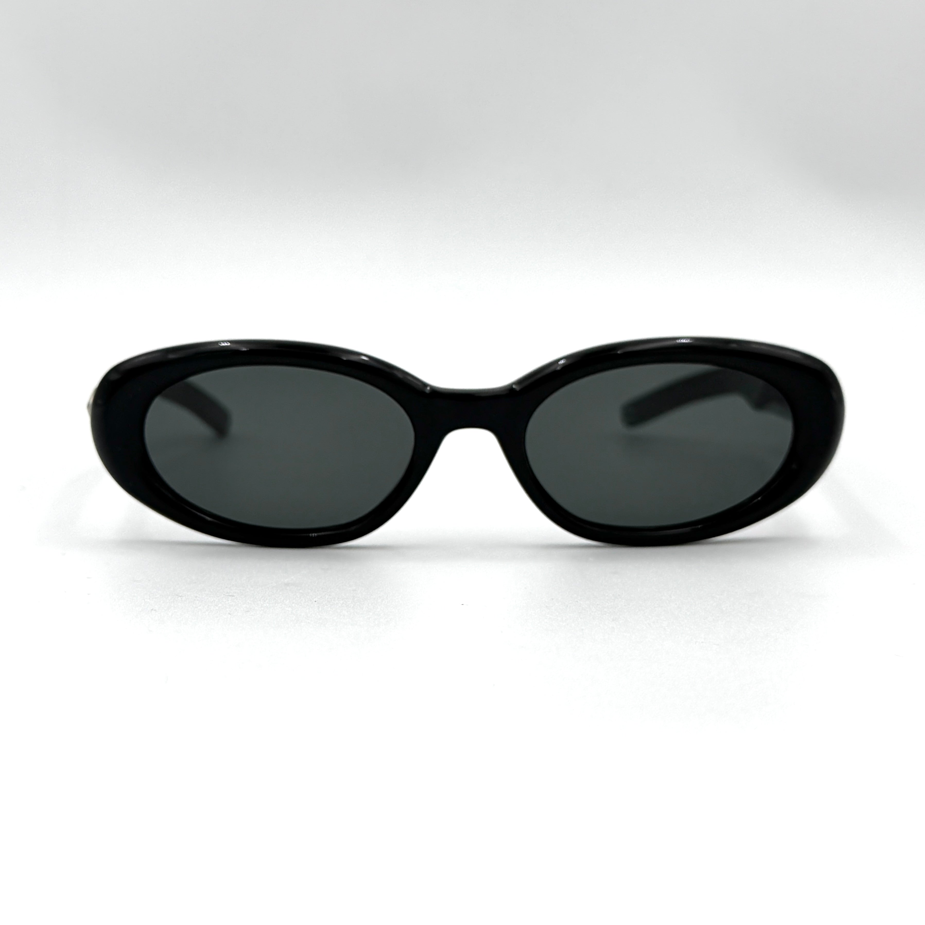 Gentle Monster Bandoneon.S sunglasses in black acetate with dark oval lenses and silver star accents shown from the side.