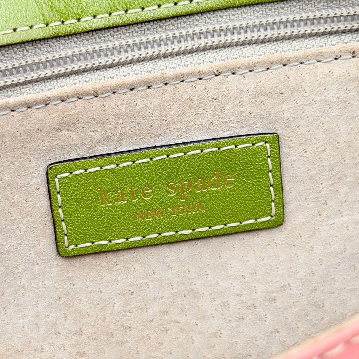 Kate Spade Morgan East West Shoulder Bag in smooth pink leather with gold-tone hardware and a green interior, displayed on white background.