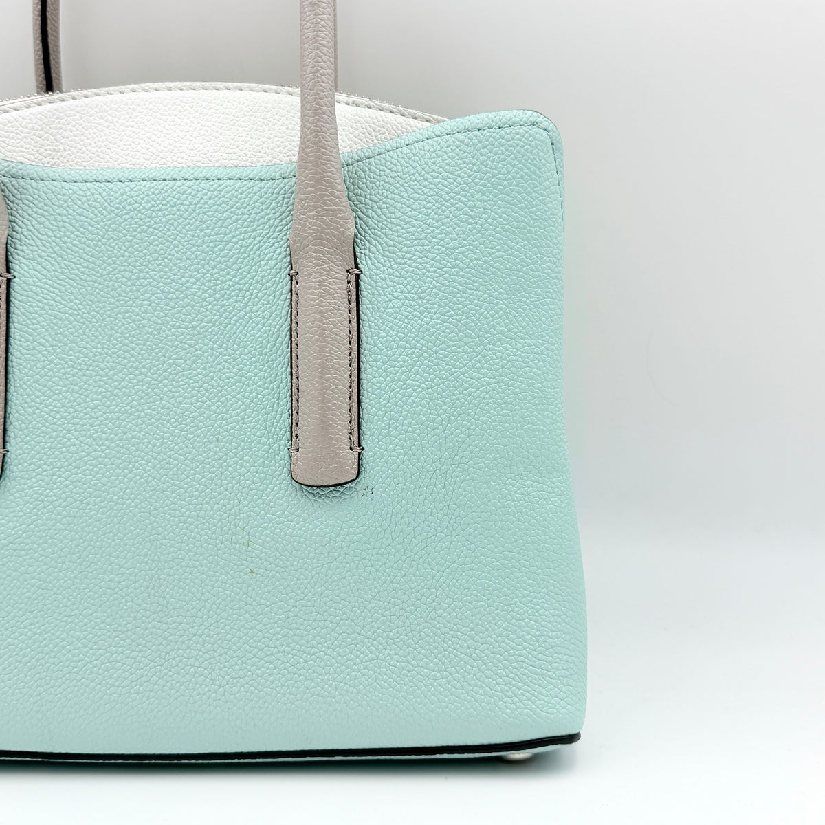 Kate Spade New York Margaux satchel in mint green pebbled leather with taupe handles, shown with its detachable strap and a clear pouch.