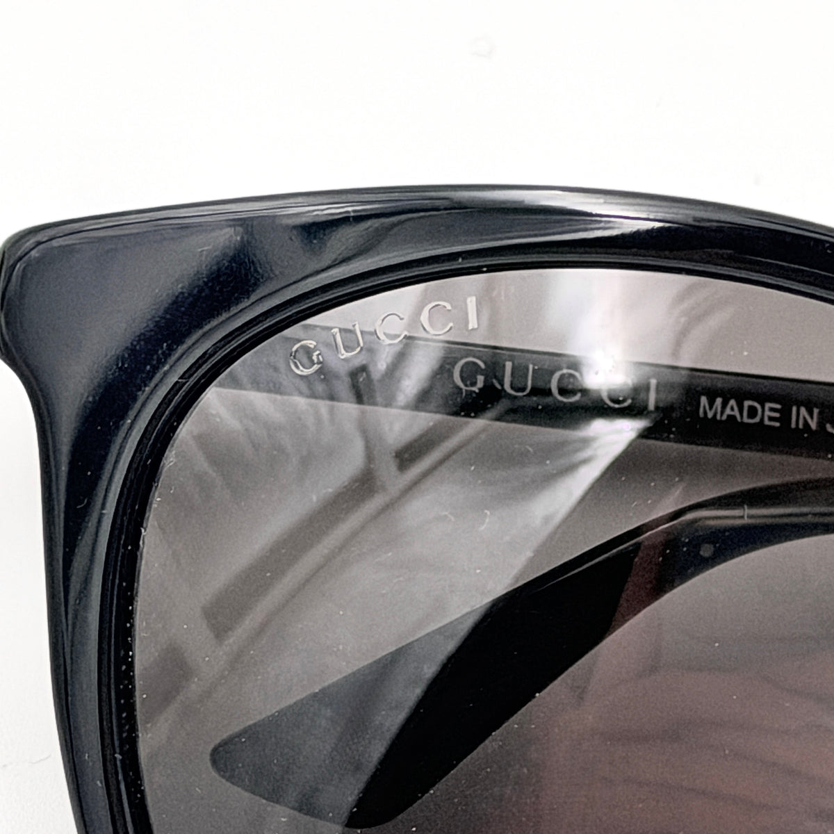 Gucci GG0064SK 001 black round sunglasses with smoky lenses, shown with original burgundy velvet case and pouch.