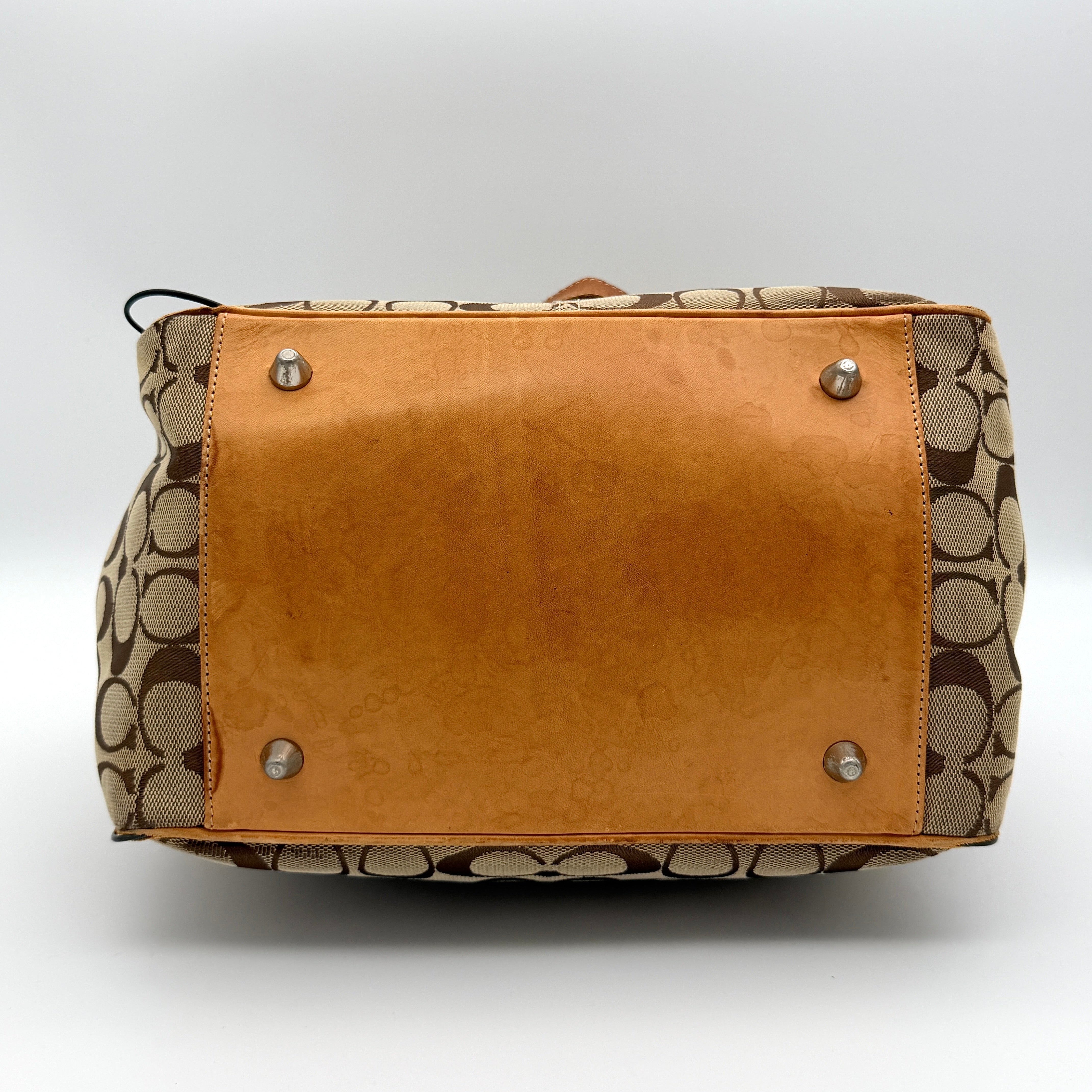 Coach Signature Buckle Tote Bag in beige and tan with signature canvas, tan leather trim, and silver-tone hardware.