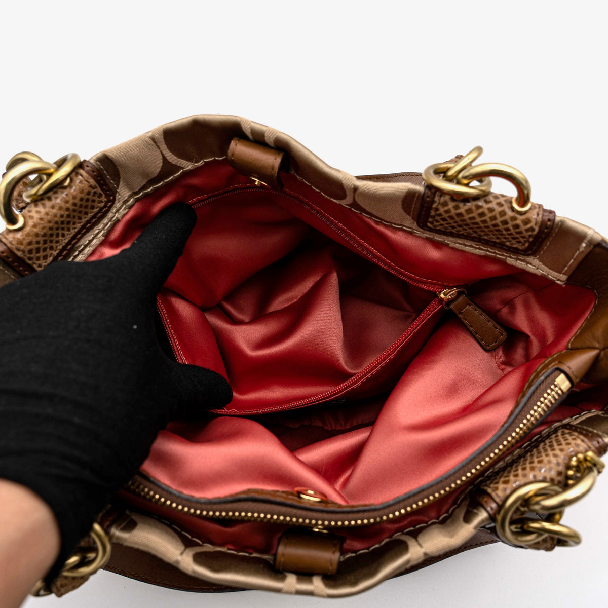 Coach Signature Peyton Shoulder Bag in brown sateen and leather with gold-tone hardware and turnlock pocket, photographed on a white background.