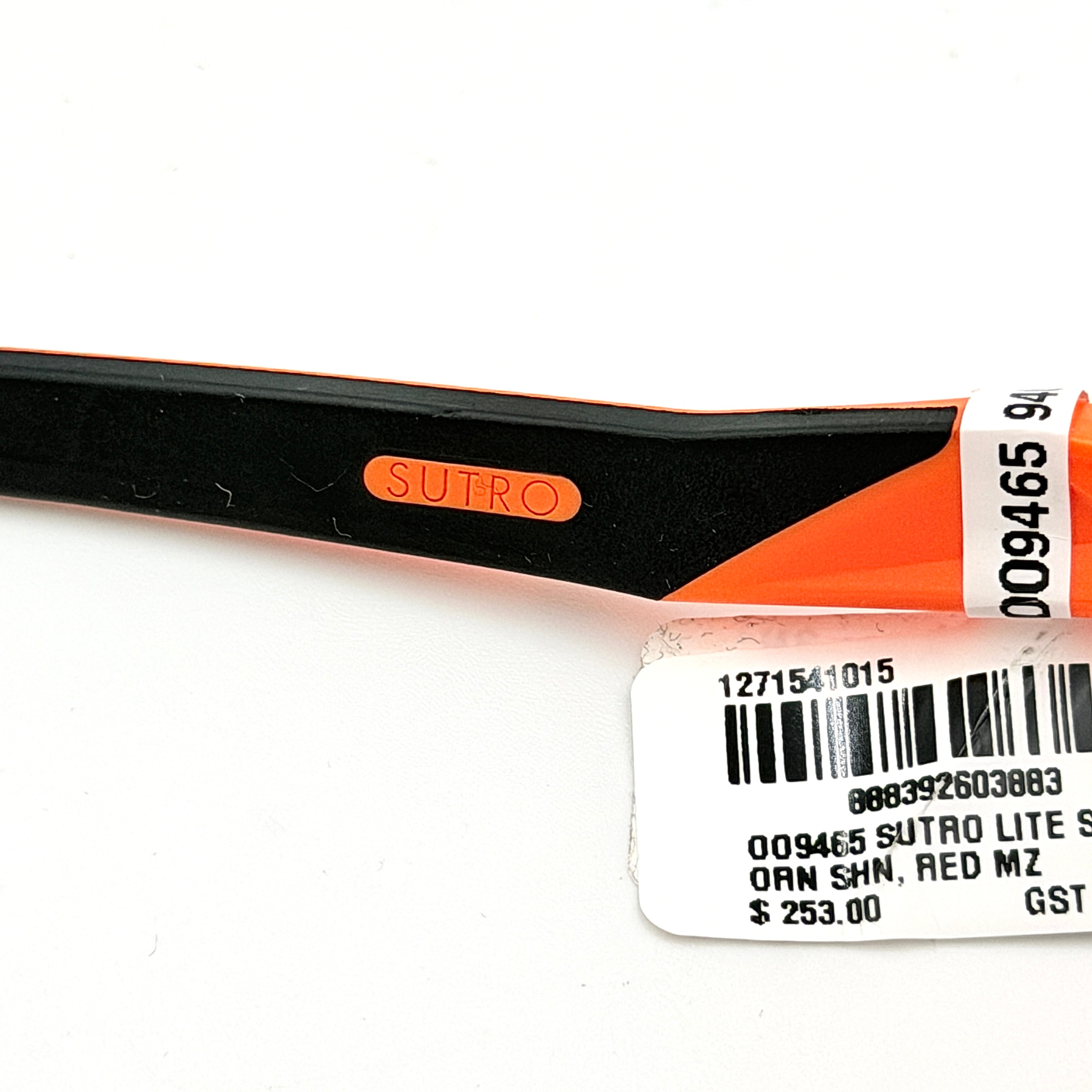 Oakley Sutro Lite Sweep MVDP Prizm Road sunglasses in orange sparkle with a shield lens and original pouch, photographed in bright studio lighting.