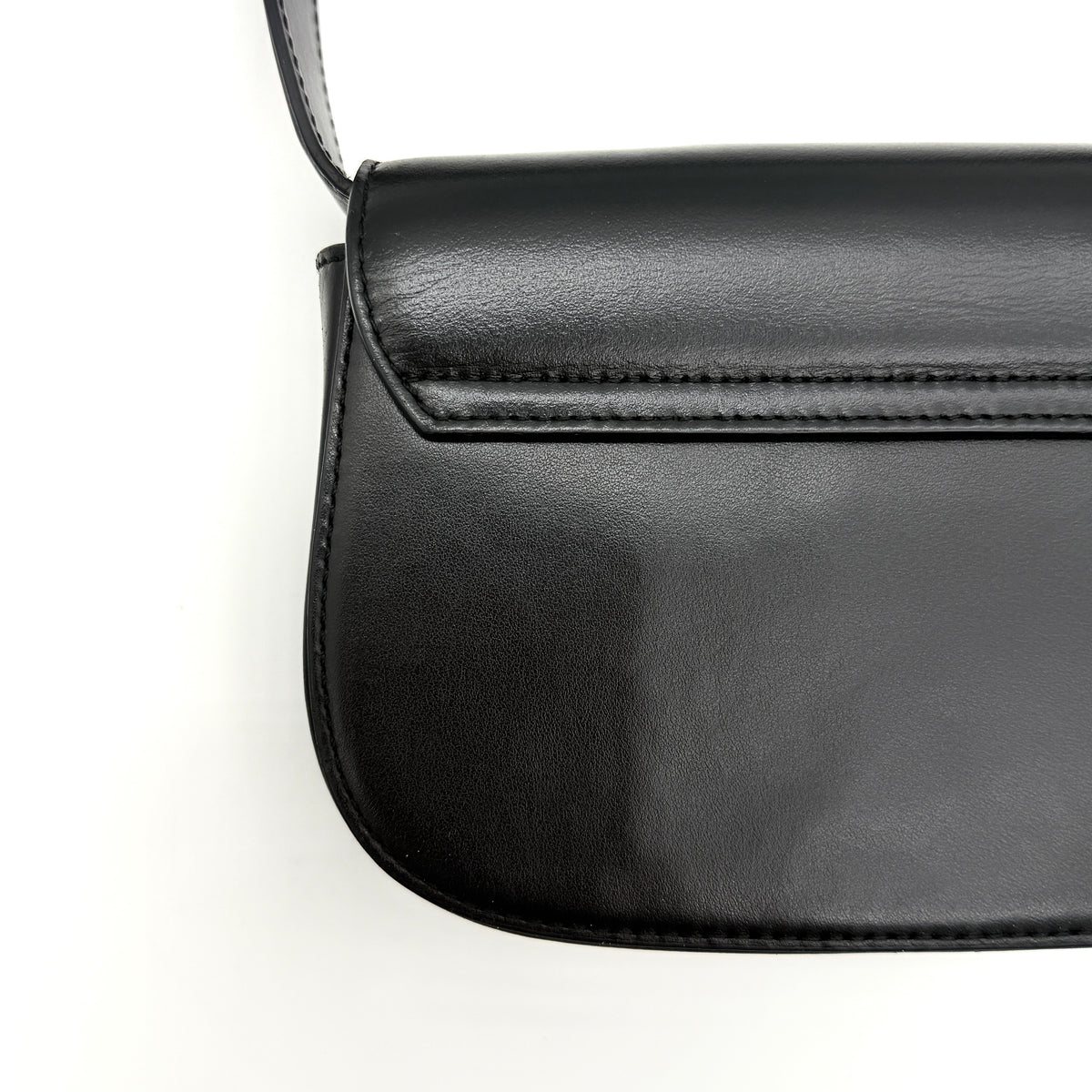 Diesel 1DR Shoulder Bag in black leather with a bold silver and black D logo plaque on the front flap.