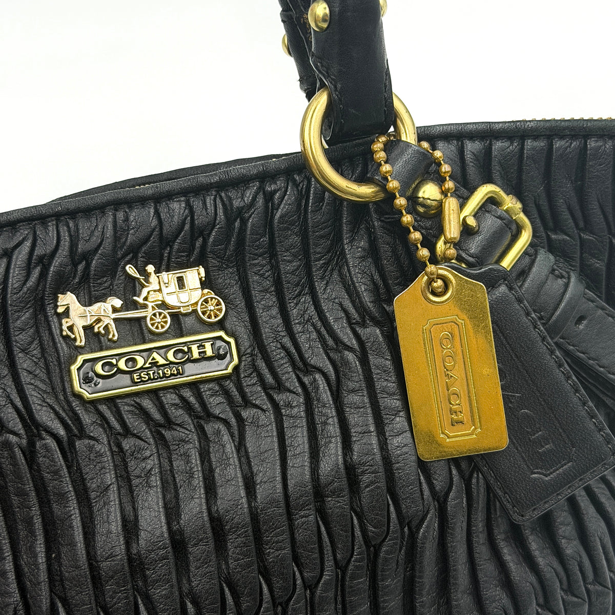 Coach Sophia Madison Pleated Shoulder Bag in black leather with gold hardware, displayed with detachable strap and dust bag.