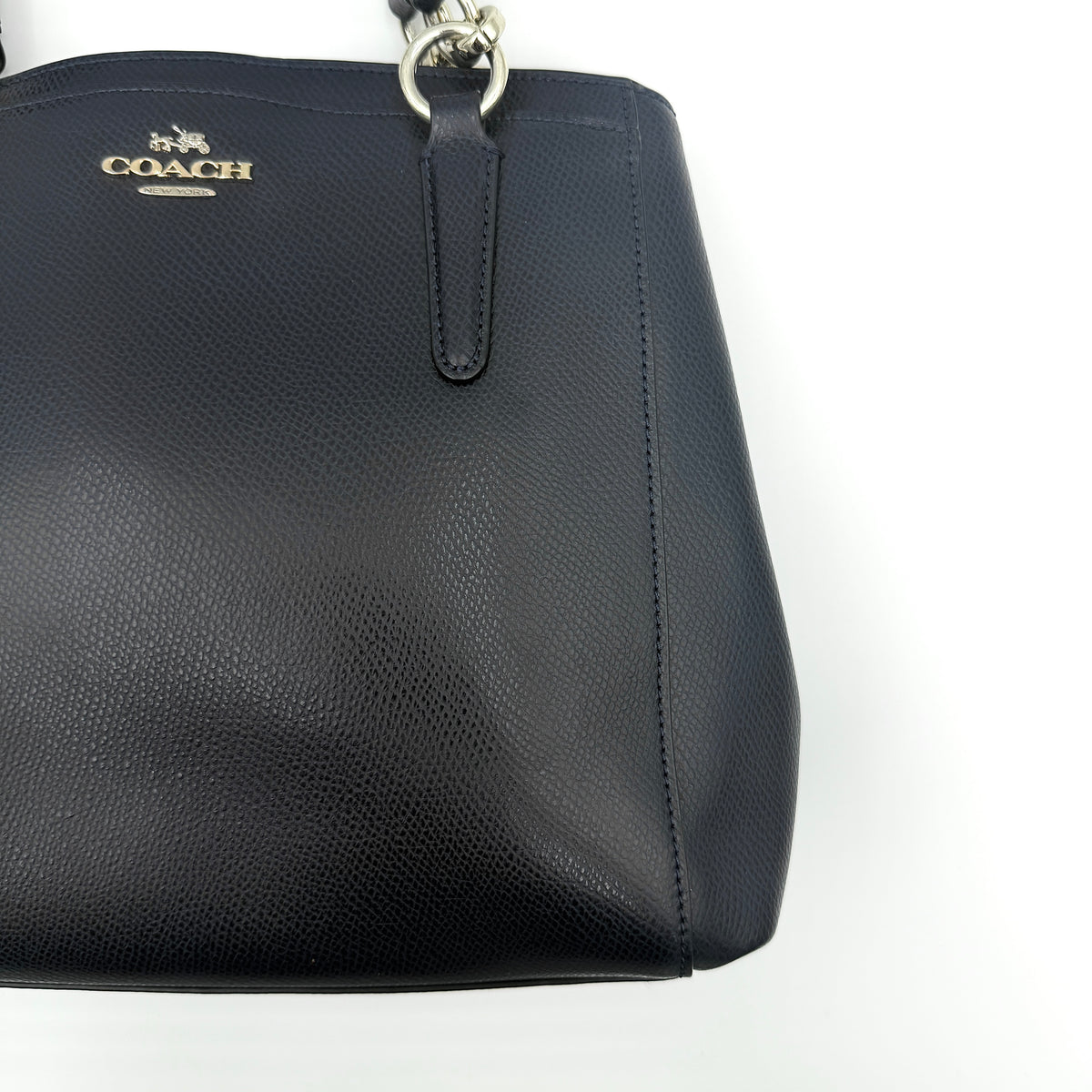 Coach Minetta Satchel in navy blue grained leather with dual handles and detachable shoulder strap displayed on a white background.