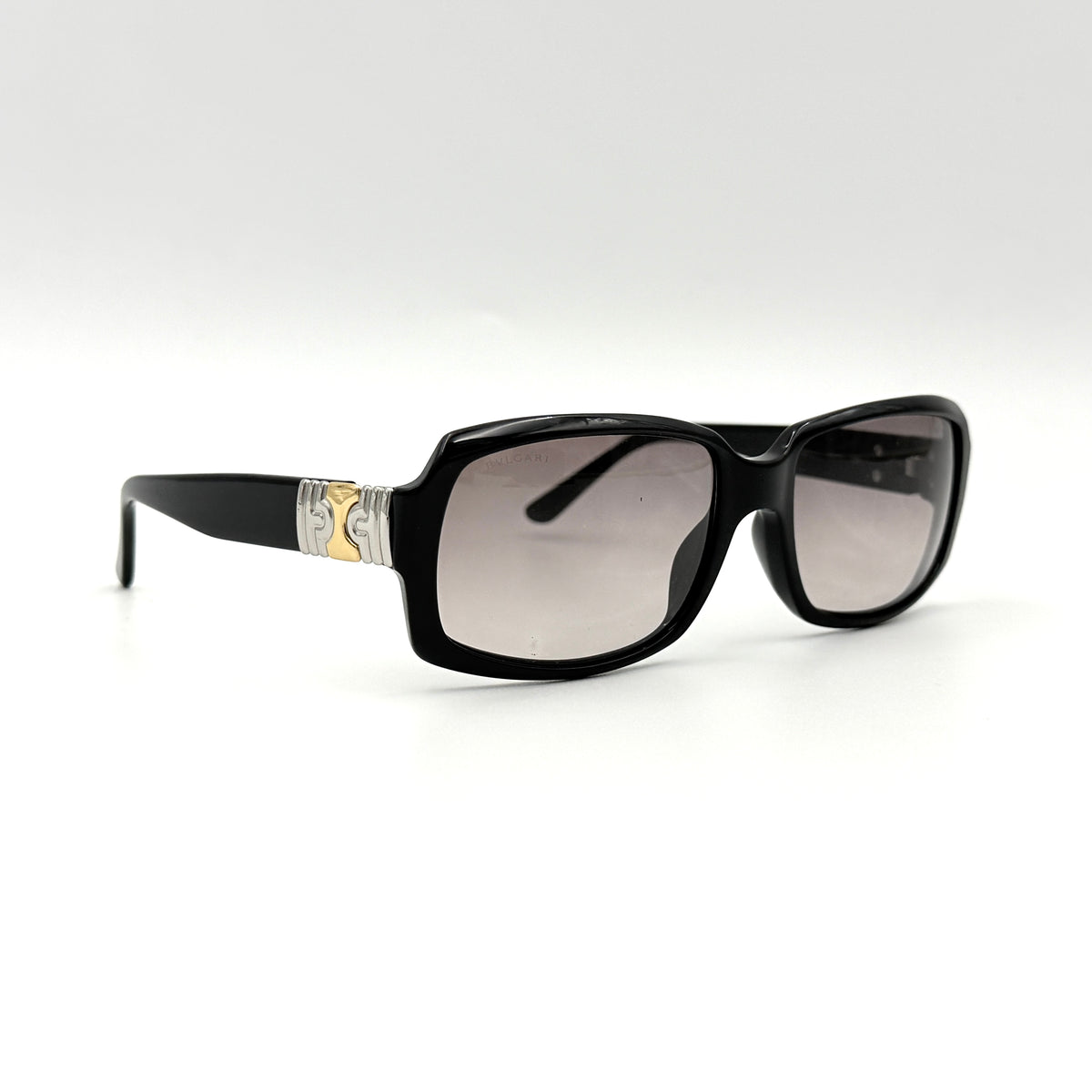 Bvlgari 829 501/11 black sunglasses with silver and gold temple hardware, displayed with case and cleaning cloth.