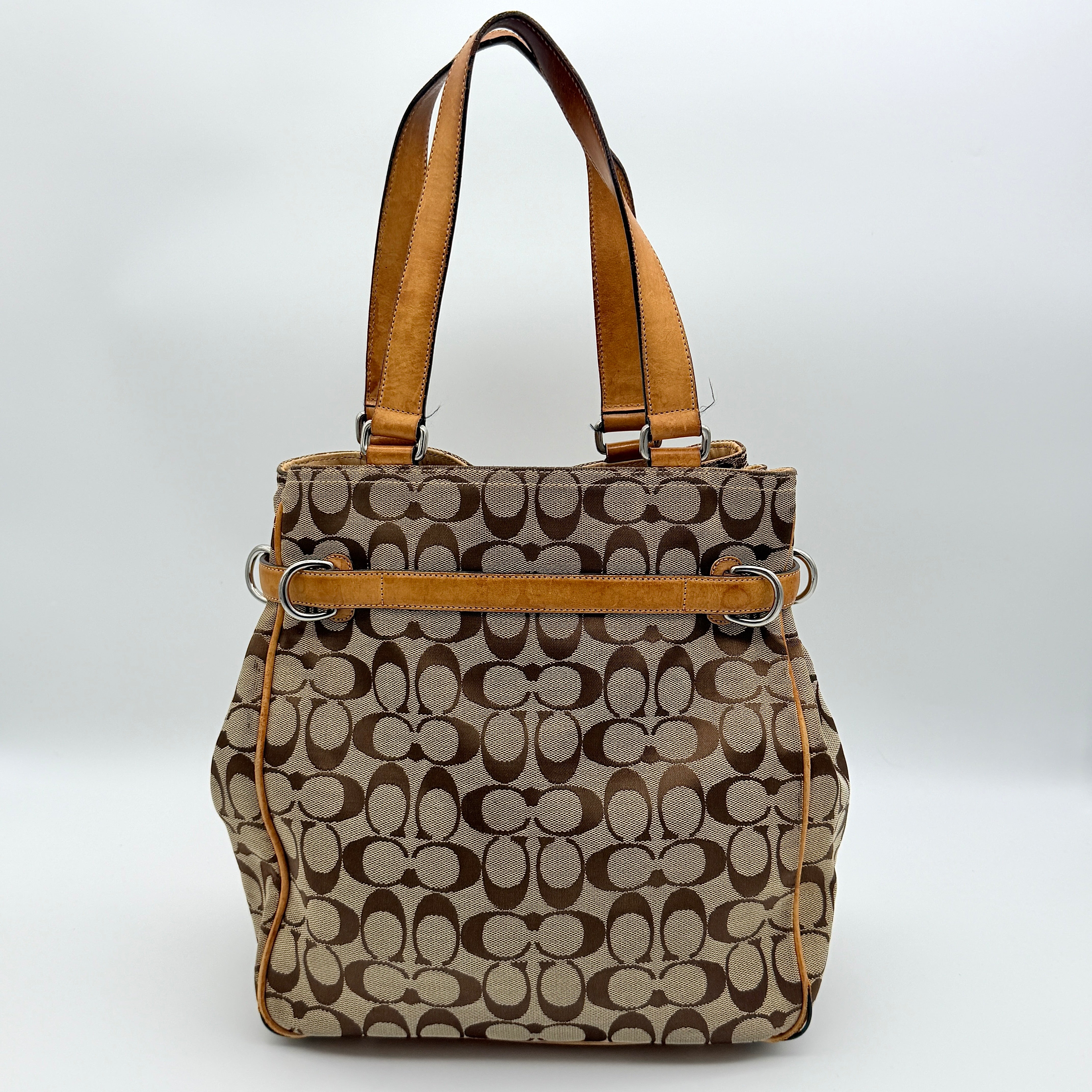 Coach Signature Buckle Tote Bag in beige and tan with signature canvas, tan leather trim, and silver-tone hardware.