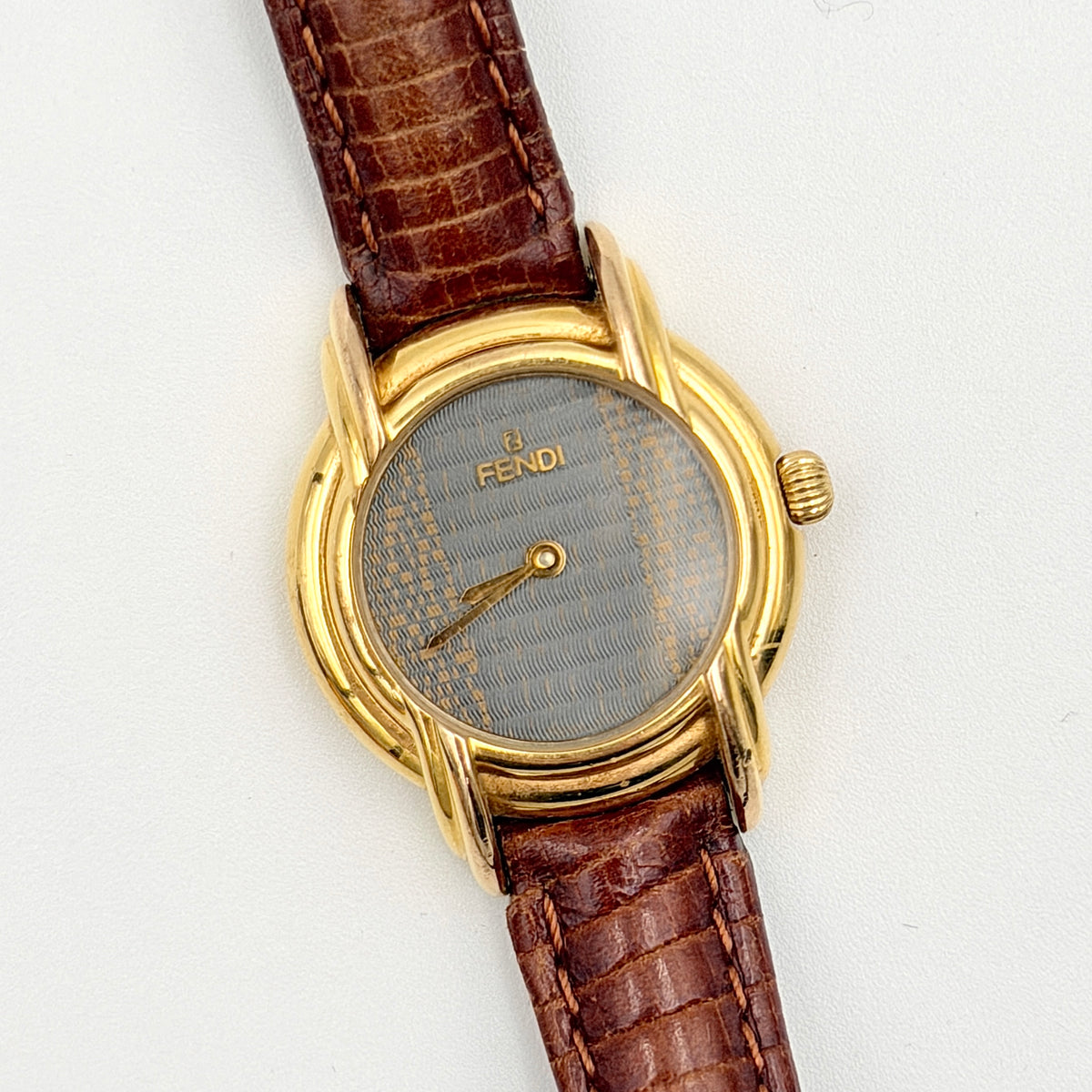 Fendi 350L Orologi Quartz Watch in gold with brown leather strap, displayed with original box and booklet.