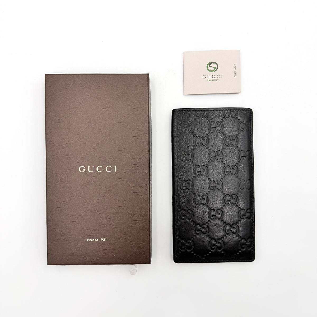 Gucci Guccissima GG embossed long wallet in black leather with box and care card.