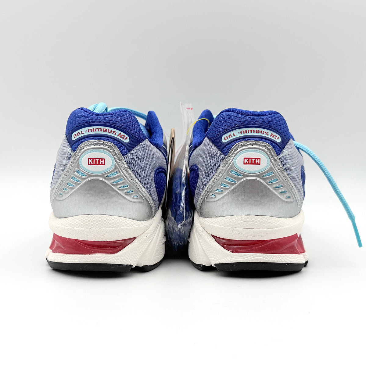 ASICS x KITH Gel-Nimbus 10.1 Mega Man sneakers in bold blue and silver, displayed with extra laces and distinctive collaboration details.