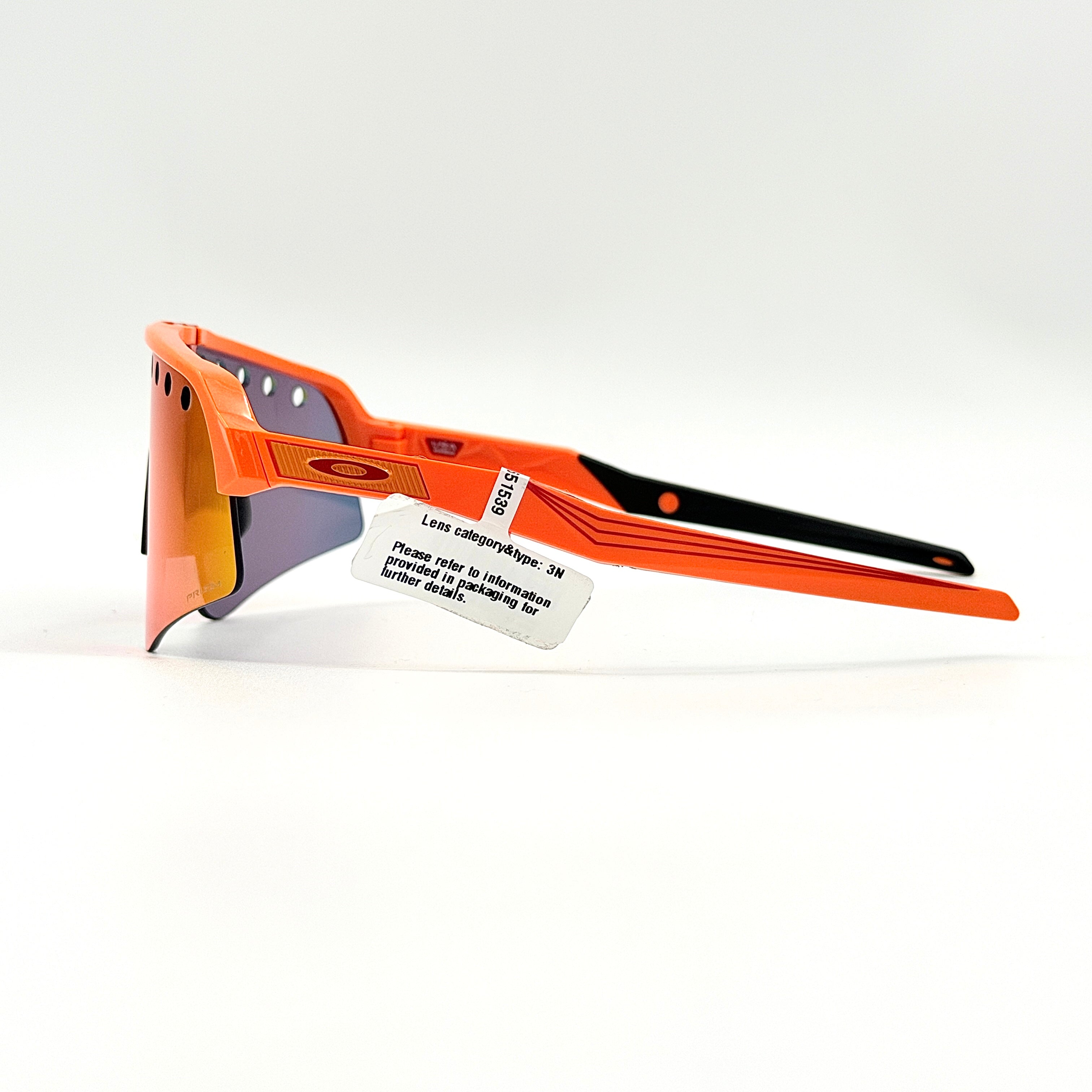 Oakley Sutro Lite Sweep MVDP Prizm Road sunglasses in orange sparkle with a shield lens and original pouch, photographed in bright studio lighting.