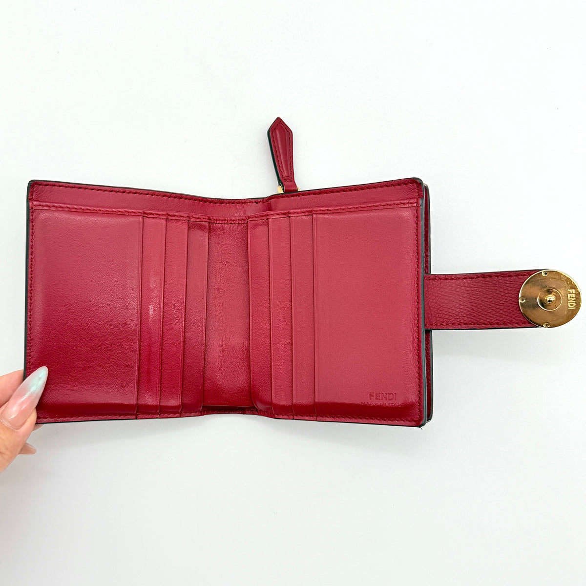 Fendi FF Embossed Logo Bifold Wallet in brown with red strap and gold Fendi hardware, displayed front on white background