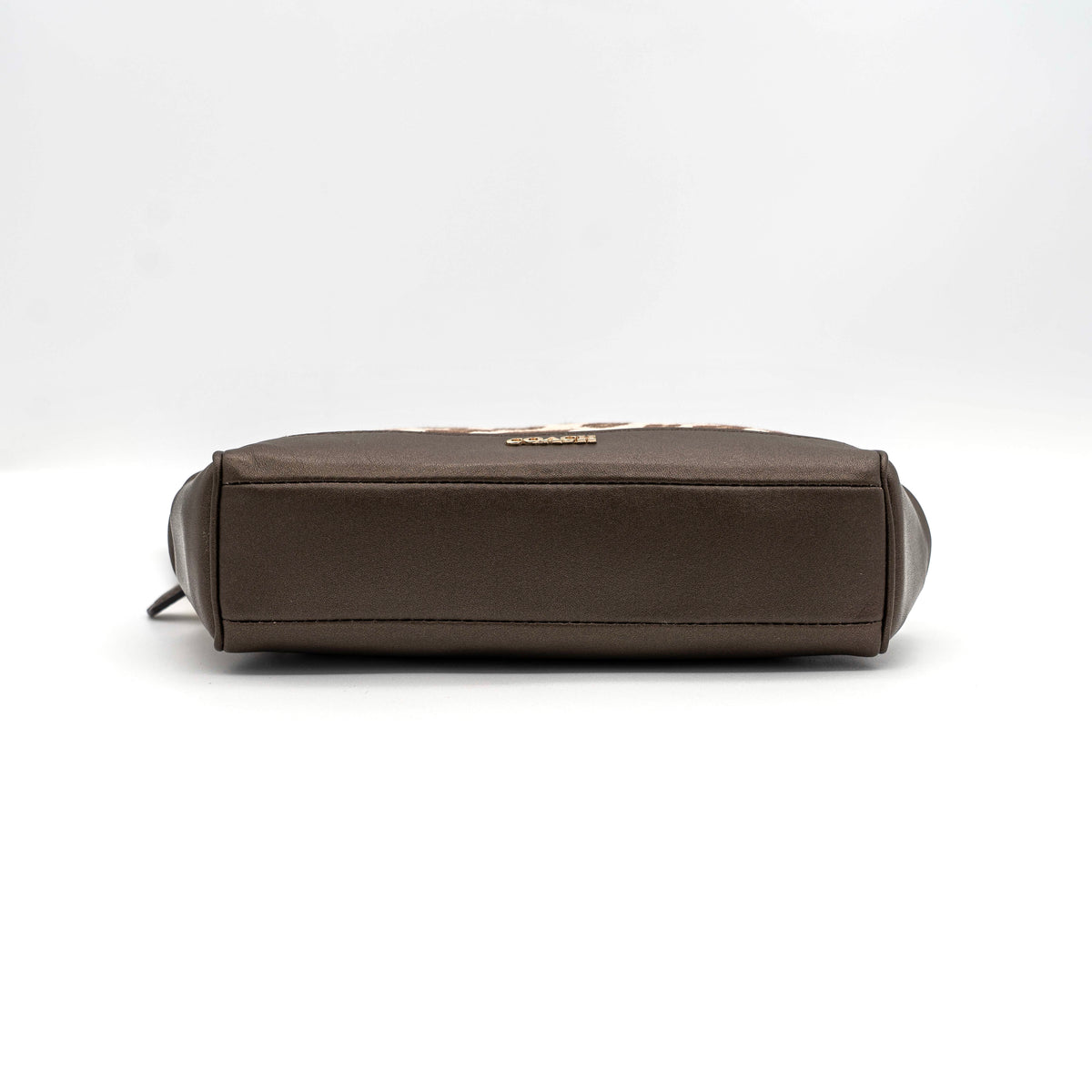 Coach cosmetic pouch in brown and beige leopard print canvas with chocolate leather trim and gold hardware, shown with wrist strap.