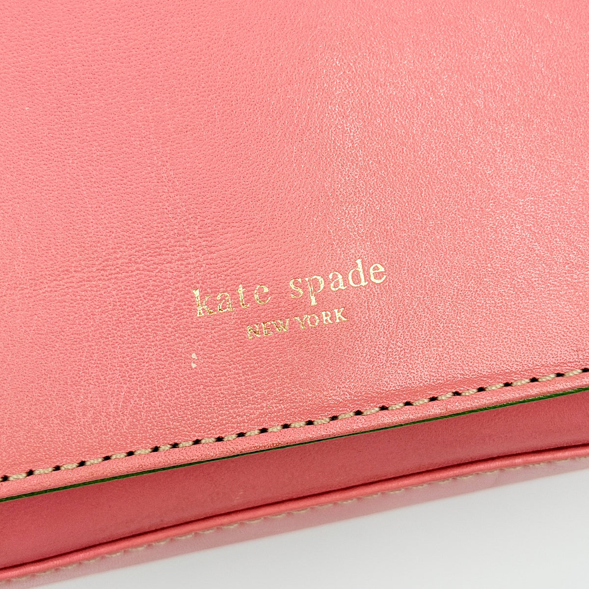 Kate Spade Morgan East West Shoulder Bag in smooth pink leather with gold-tone hardware and a green interior, displayed on white background.