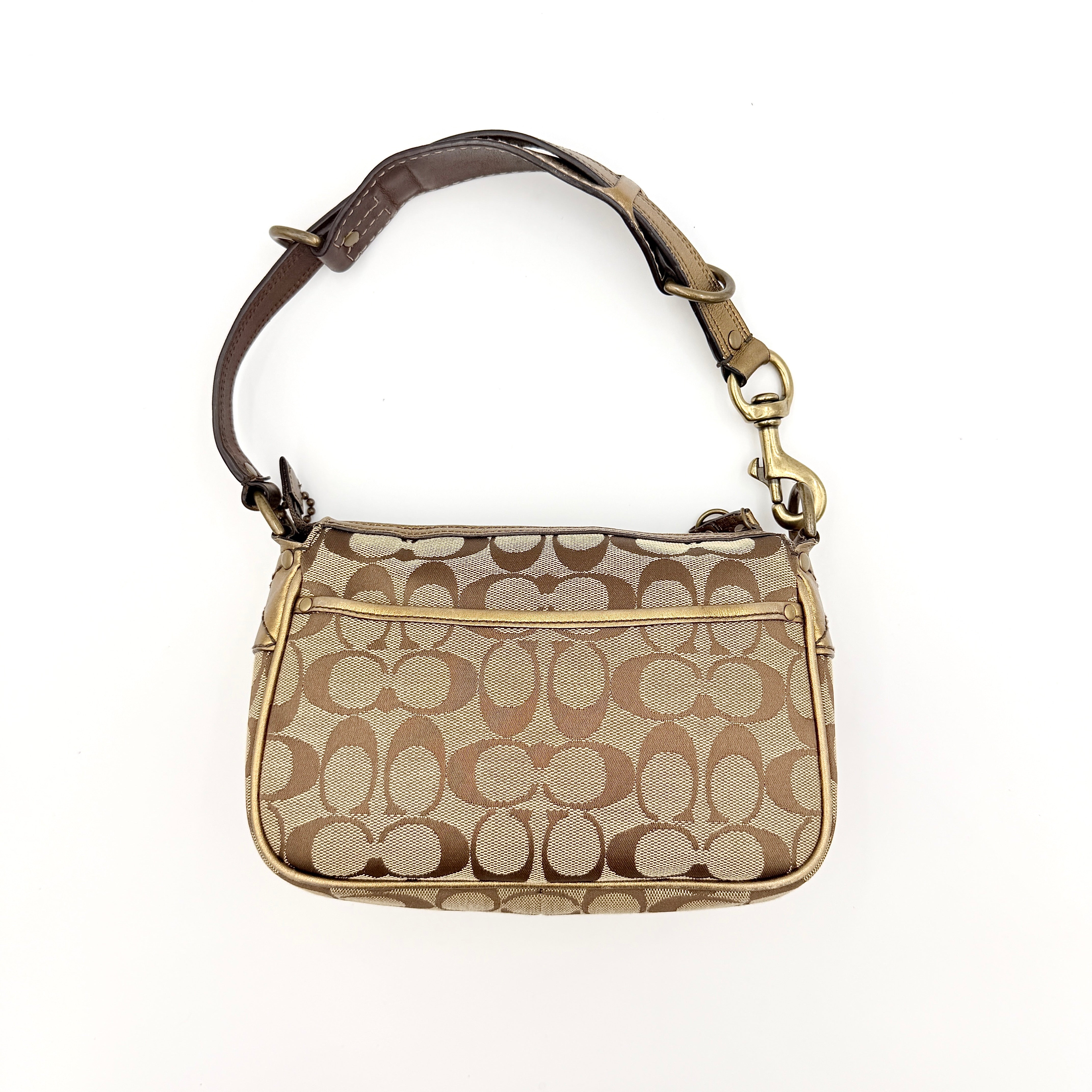 Coach Signature shoulder bag in beige jacquard with gold leather front flap, showcased on a plain background.
