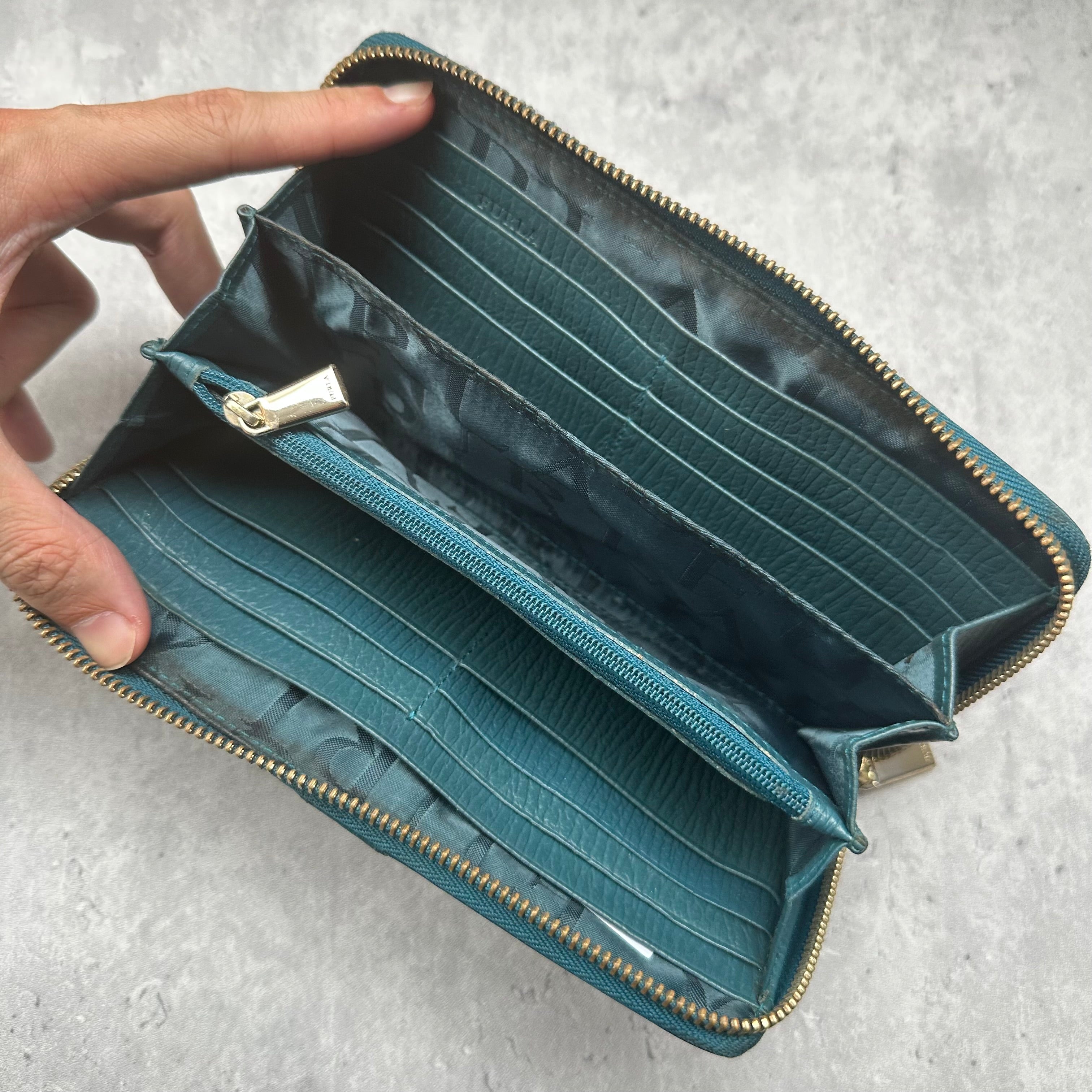 Furla Babylon Green Leather Zip Wallet with gold zipper and multiple card slots in a textured finish