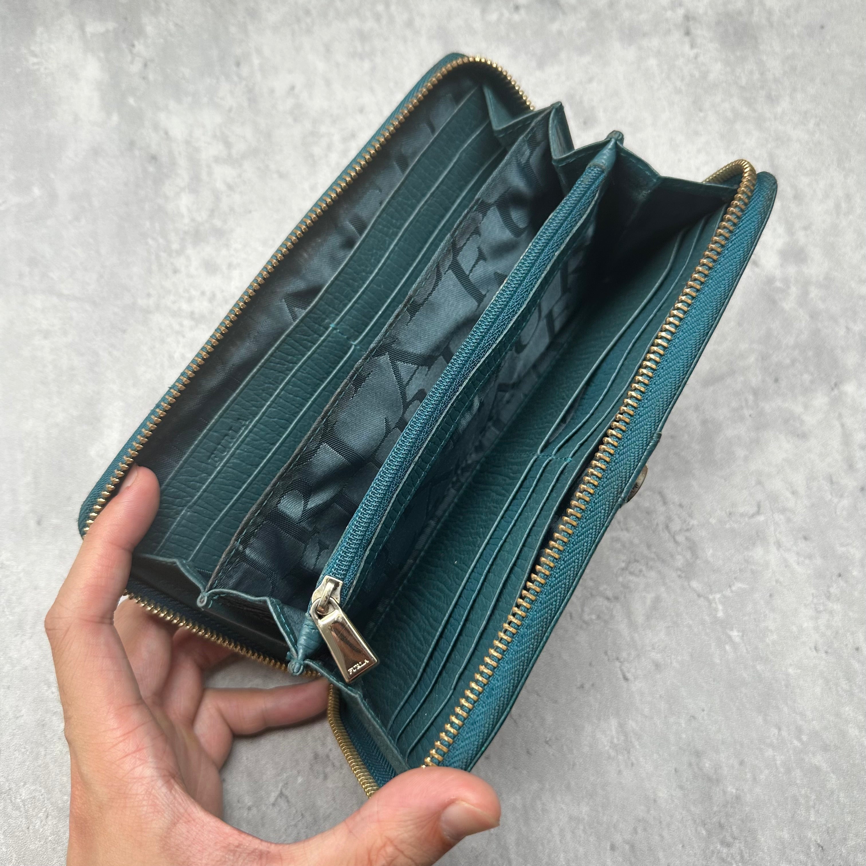 Furla Babylon Green Leather Zip Wallet with gold zipper and multiple card slots in a textured finish
