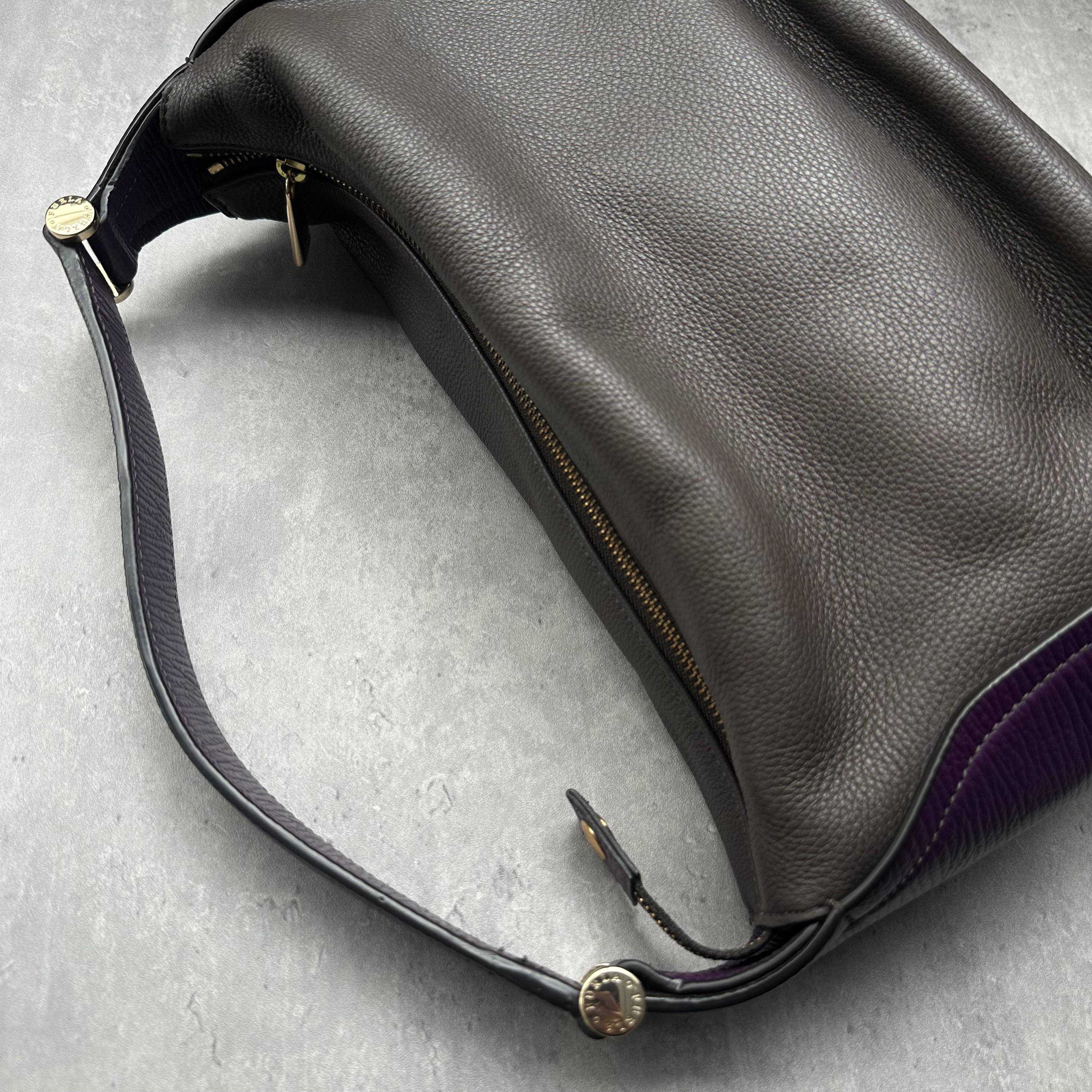 Furla Cindy Hobo Bag in brown pebbled leather with purple trim, gold zip closure, and logo-printed interior lining