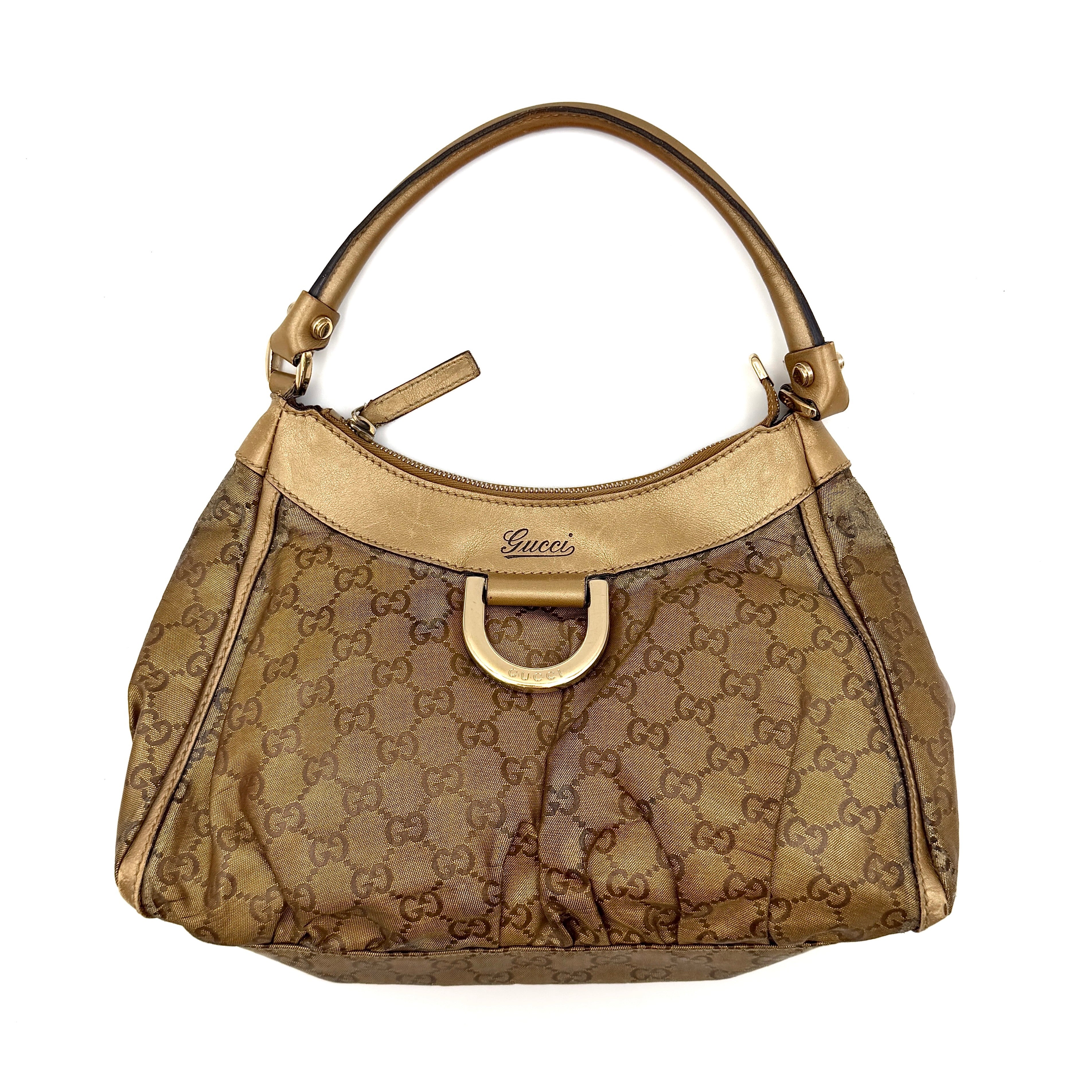 Gucci GG Monogram D-Ring Shoulder Bag in metallic gold with patent leather trim, pleated body, and gold-tone hardware.