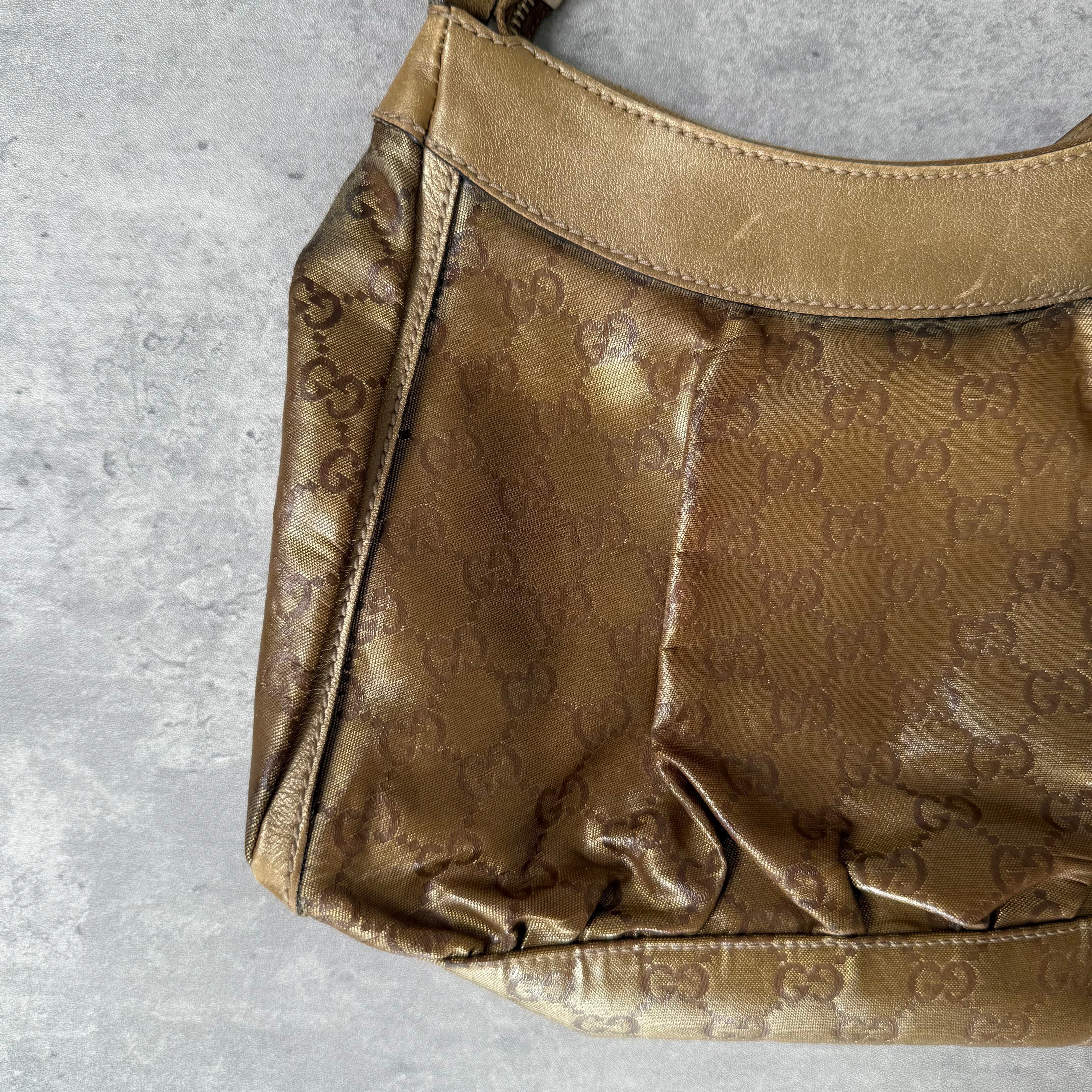 Gucci GG Monogram D-Ring Shoulder Bag in metallic gold with patent leather trim, pleated body, and gold-tone hardware.