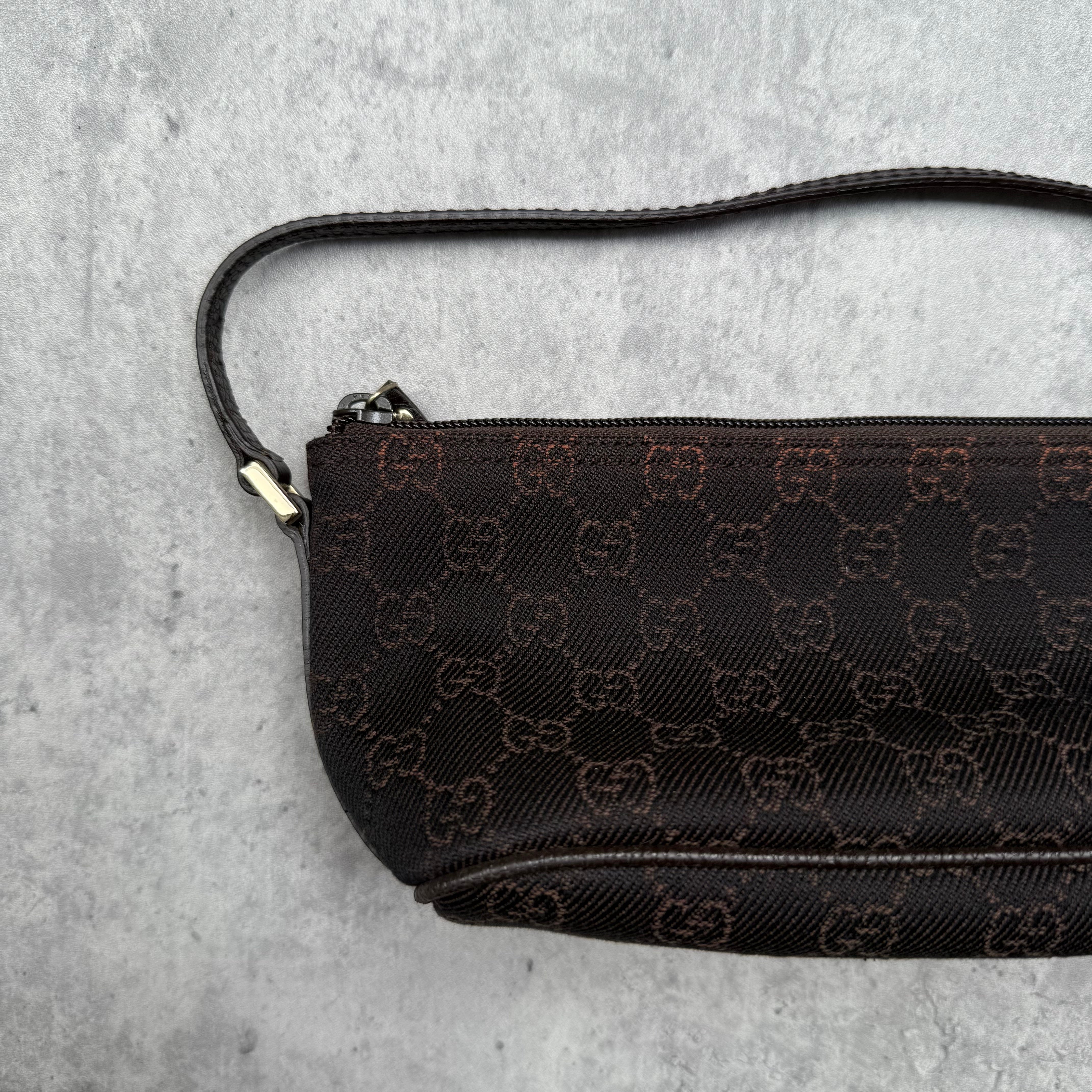 Gucci GG Monogram Pochette Boat Shoulder Bag in black canvas with tonal trim, top zip closure, and minimalist silhouette.