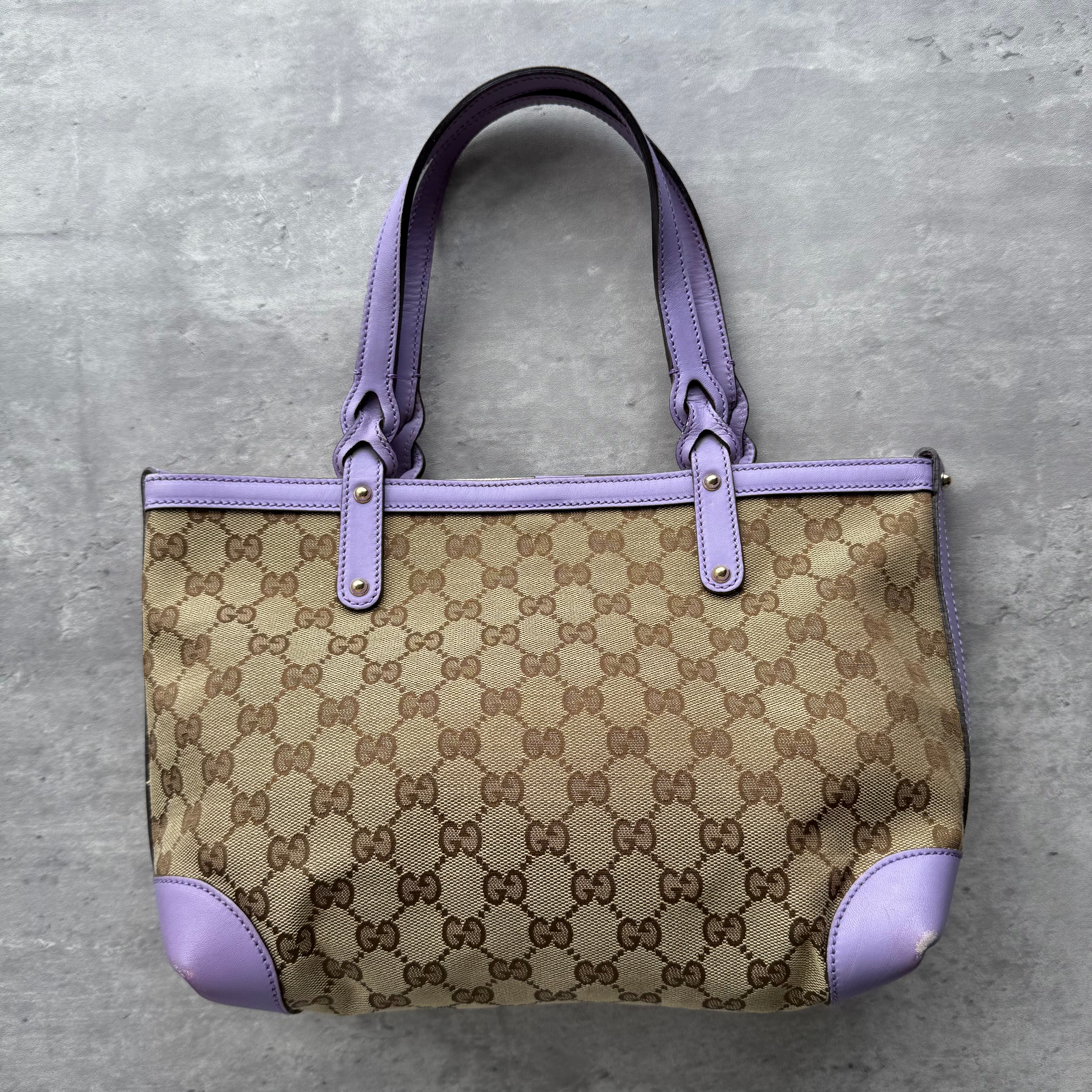 Gucci GG Monogram Shoulder Bag in beige with purple leather trim, featuring gold-tone hardware and open-top design.