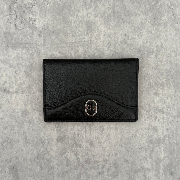 Gucci Interlocking G Black Leather Cardholder, featuring pebbled leather and silver-tone logo hardware in a slim bifold design