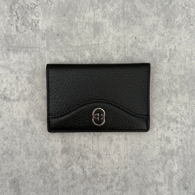 Gucci Interlocking G Black Leather Cardholder, featuring pebbled leather and silver-tone logo hardware in a slim bifold design