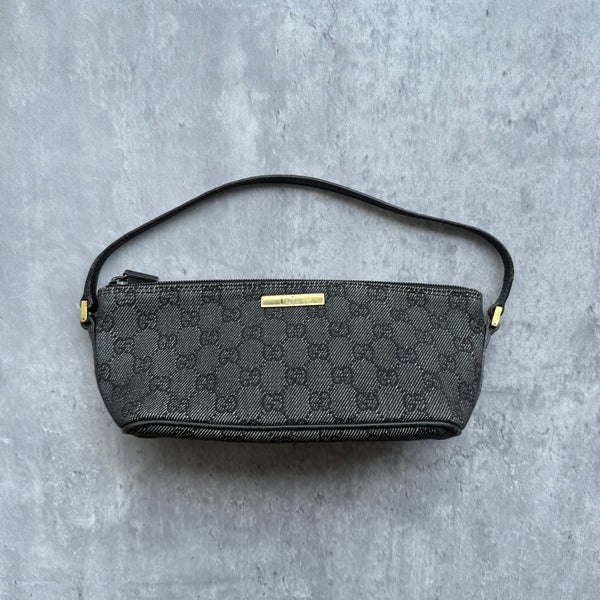 Gucci Pochette Boat Shoulder Bag in black GG monogram canvas with gold-tone logo plaque and black leather strap.