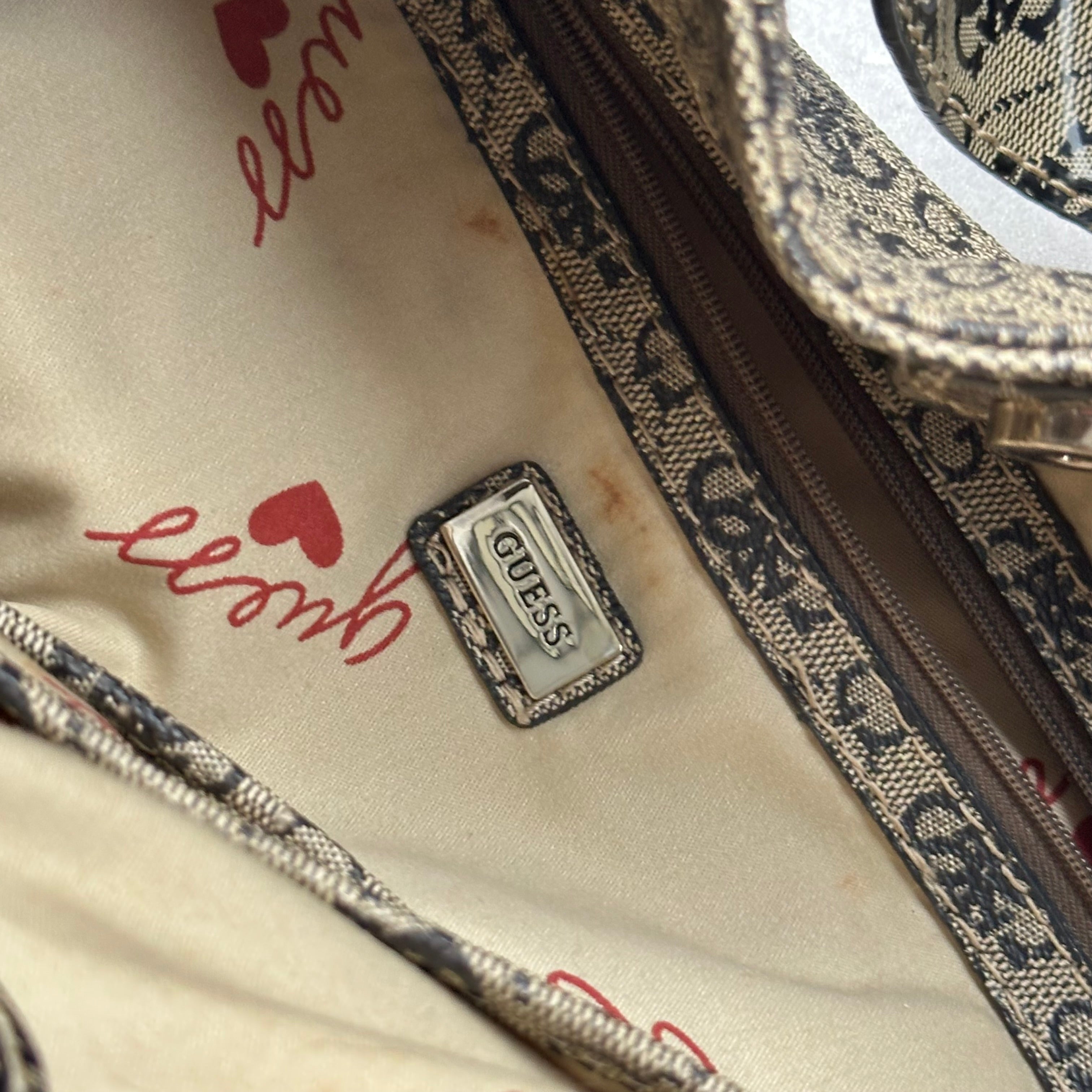 Guess Faux Fur Crossbody Bag, featuring monogram logo print in taupe faux leather with silver-tone hardware, patent trim, and heart-print interior lining.