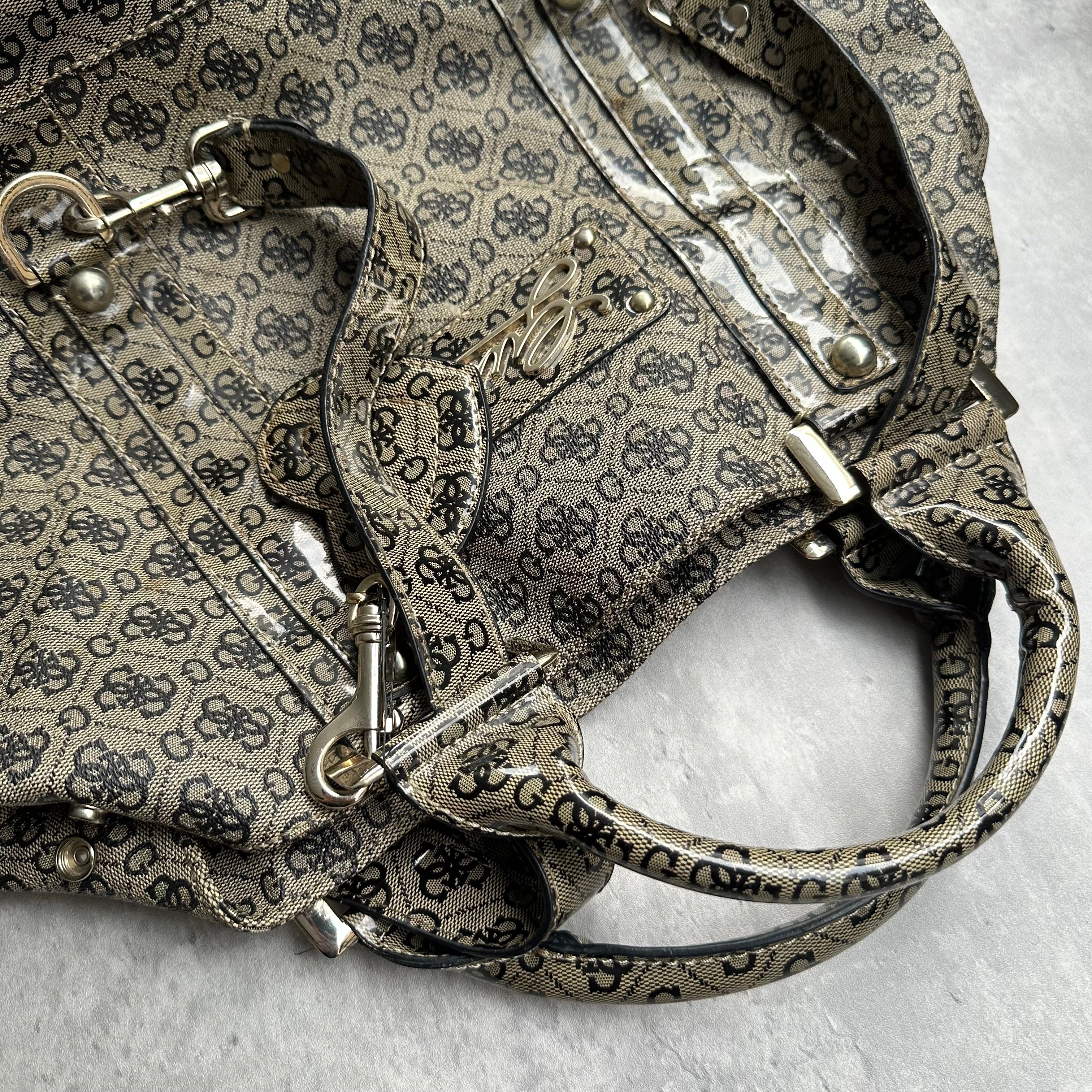 Guess Faux Fur Crossbody Bag, featuring monogram logo print in taupe faux leather with silver-tone hardware, patent trim, and heart-print interior lining.