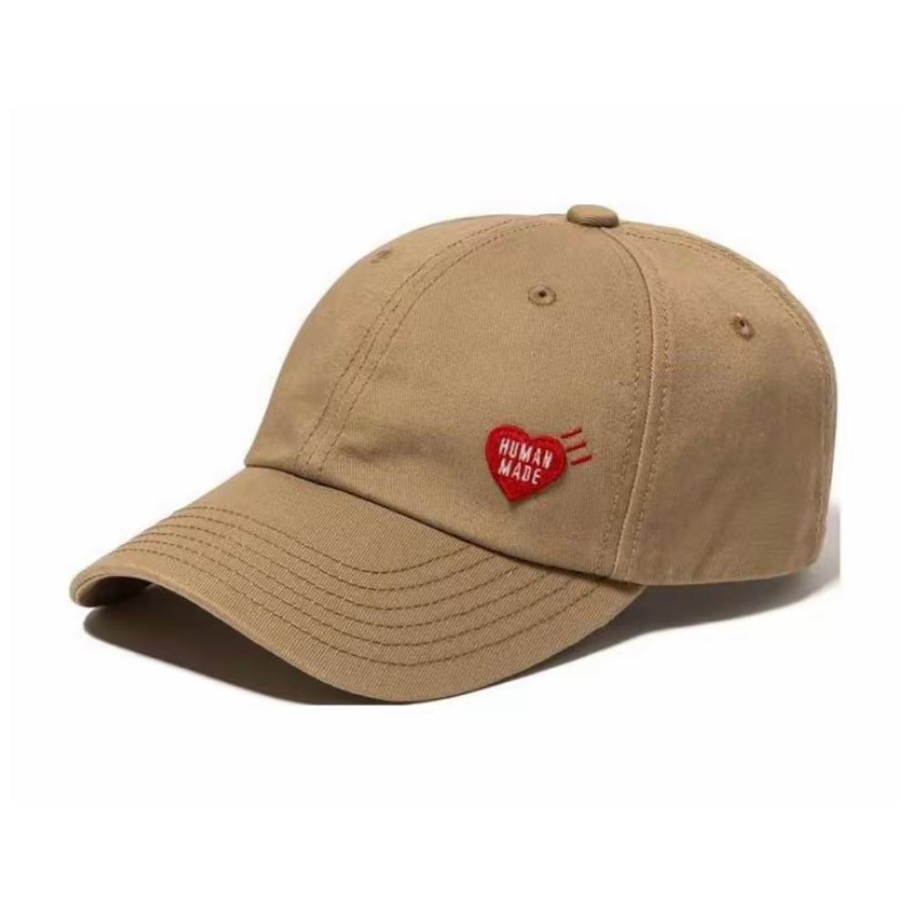 Human Made 6 Panel Twill Cap Beige, featuring red heart logo on front, DRY ALLS embroidery on back, and adjustable strap in cotton twill.