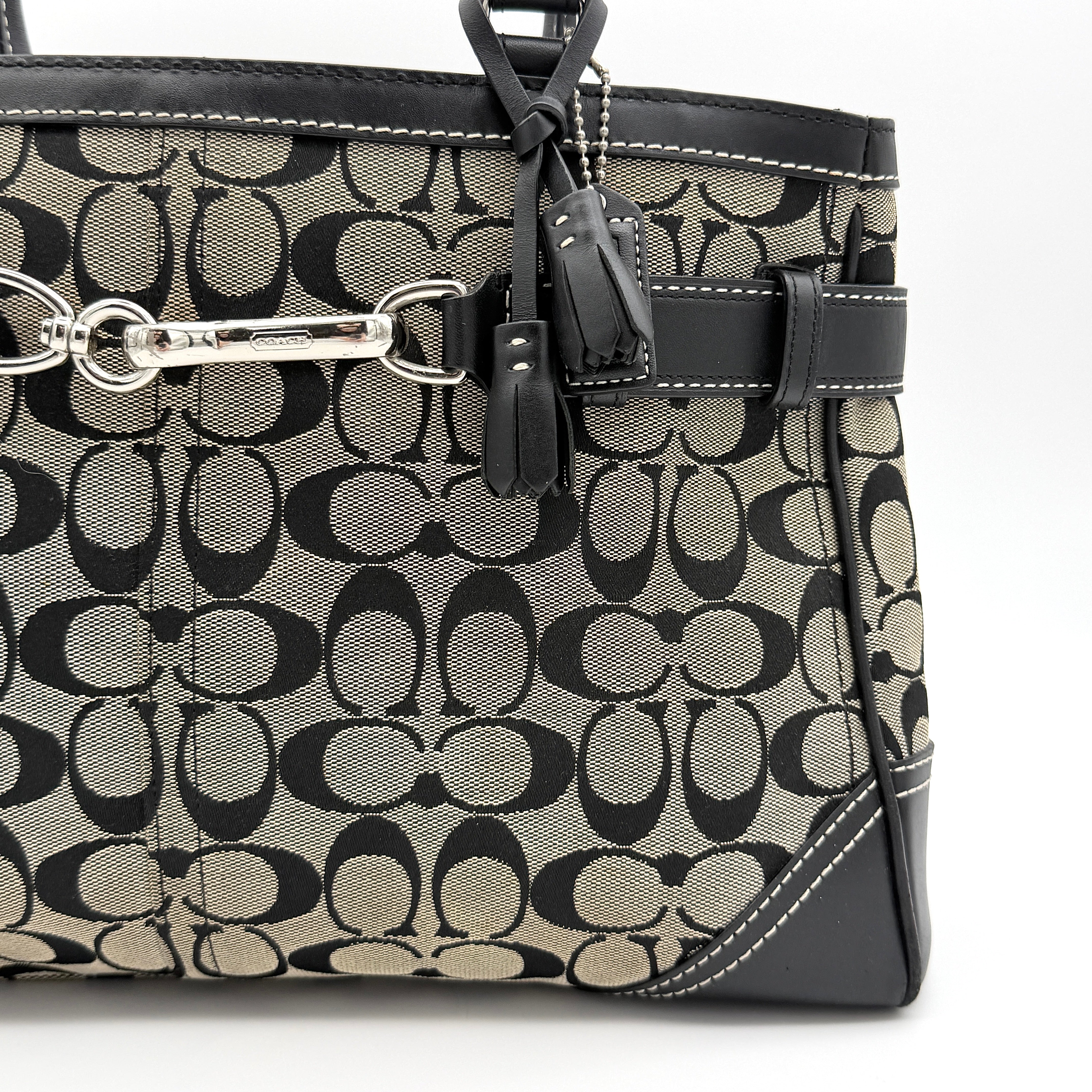 Coach Signature Hampton Clip Shoulder Bag in grey and black canvas with leather trim and silver-tone hardware, displayed with double handles.