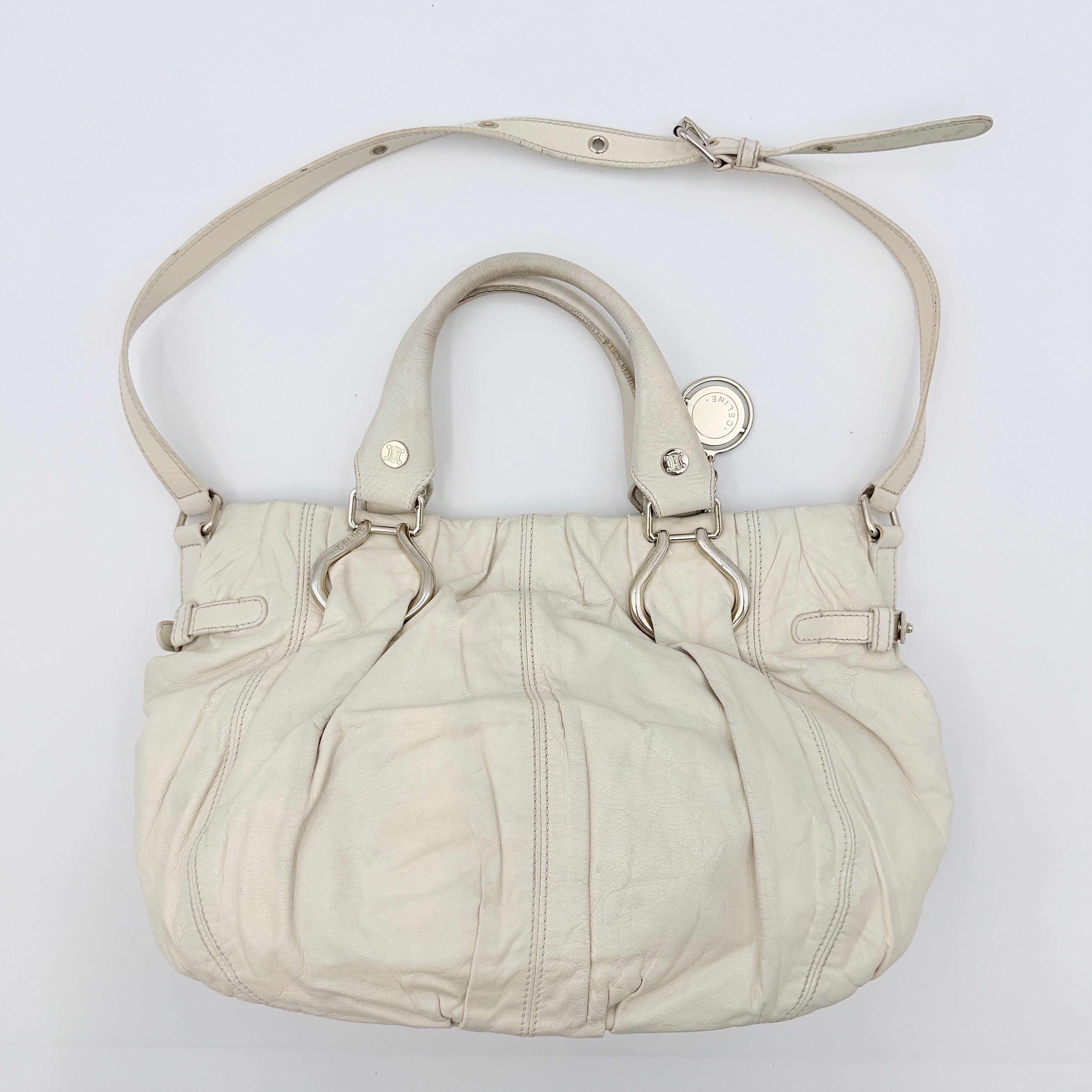 Celine 2Way Leather Shoulder Bag in white leather with architectural silver hardware, top handles, and an adjustable shoulder strap.