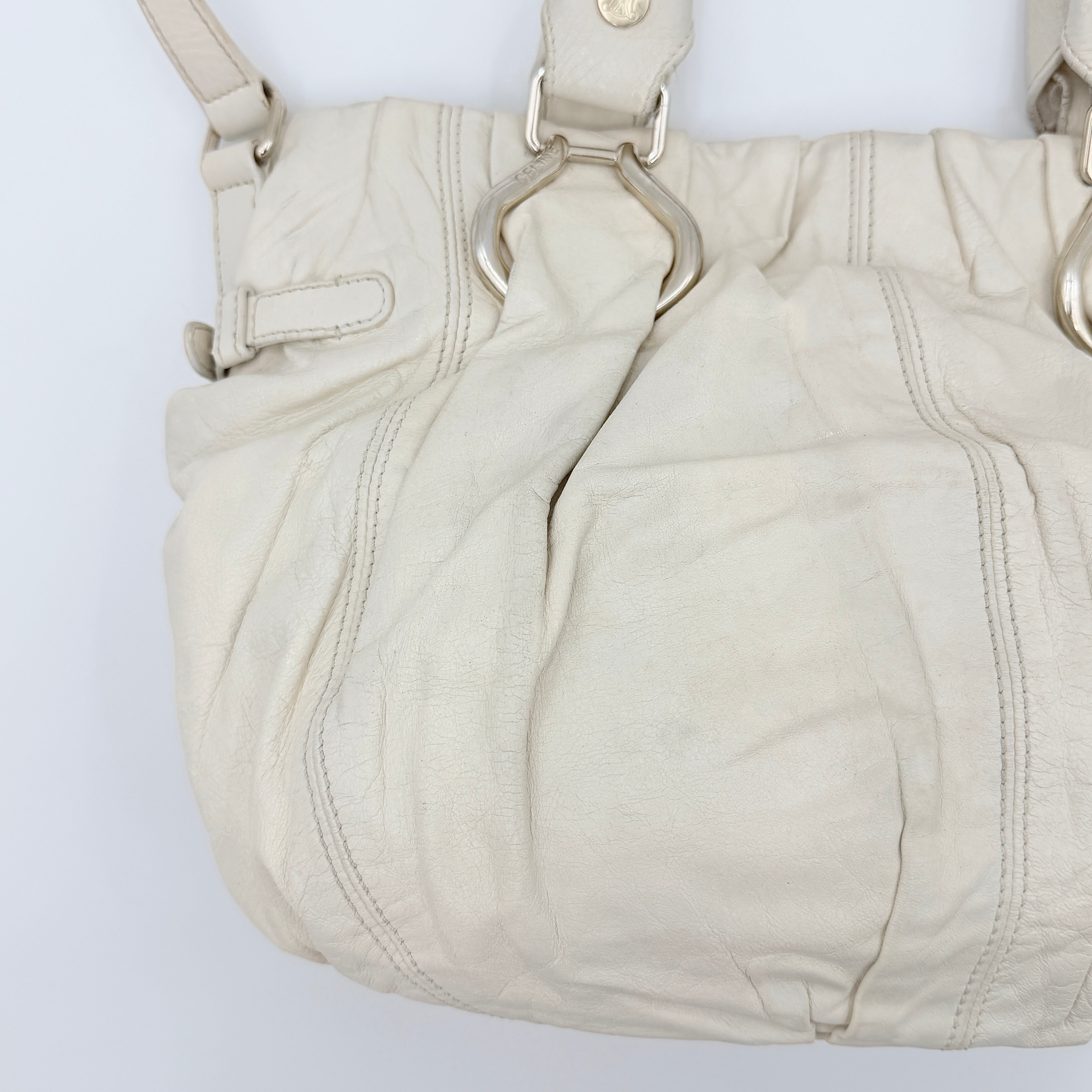Celine 2Way Leather Shoulder Bag in white leather with architectural silver hardware, top handles, and an adjustable shoulder strap.