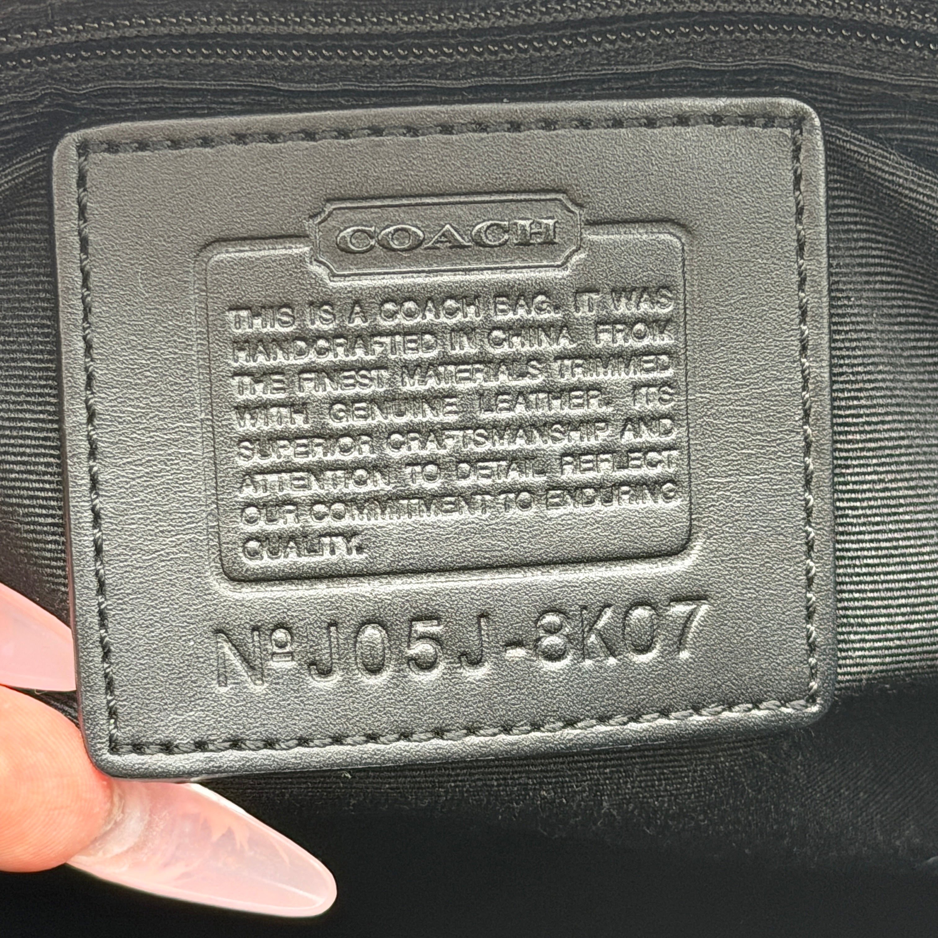 Coach Signature Hampton Clip Shoulder Bag in grey and black canvas with leather trim and silver-tone hardware, displayed with double handles.