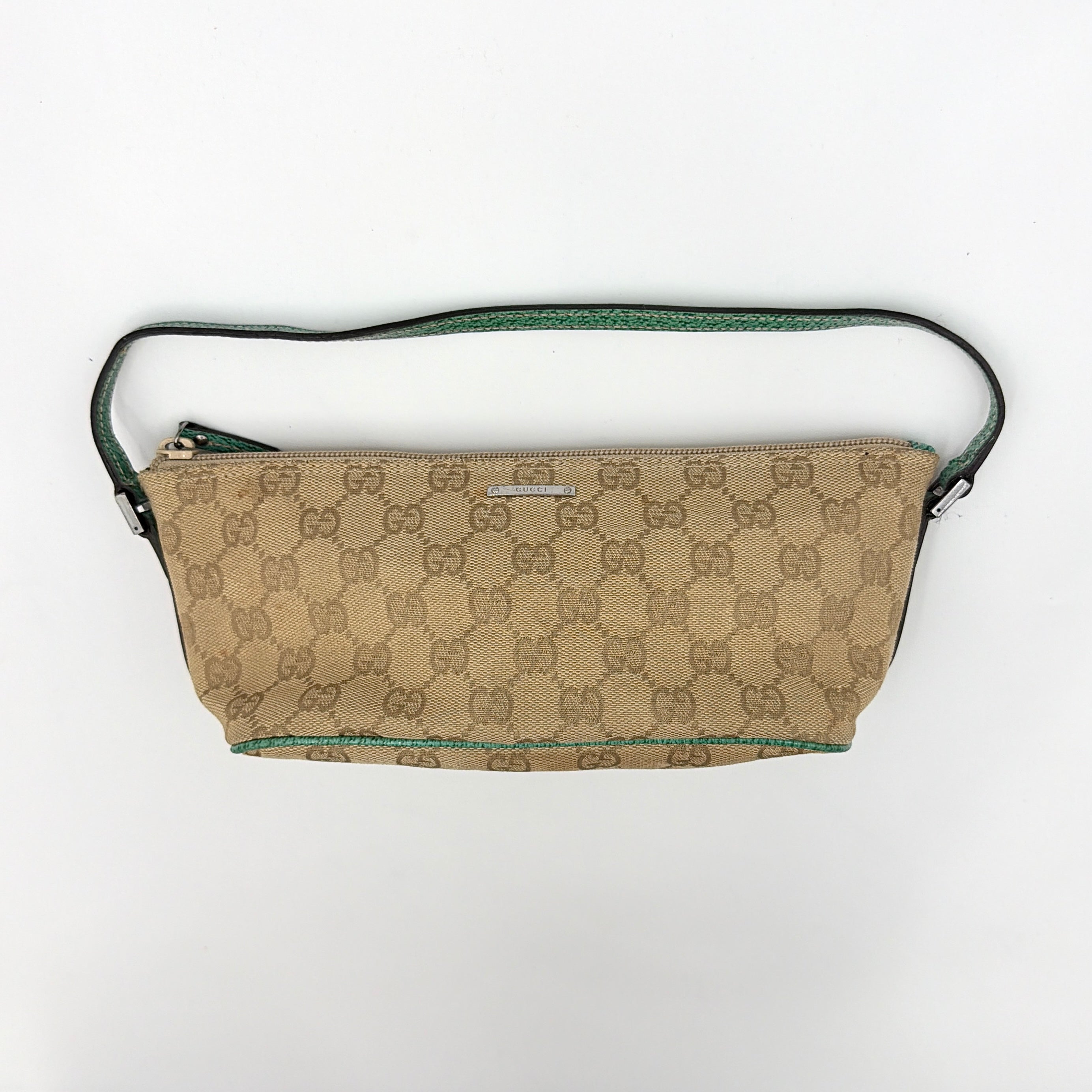Gucci GG Monogram Pochette Boat Shoulder Bag in beige canvas with green leather trim and a structured, boat-shaped silhouette.