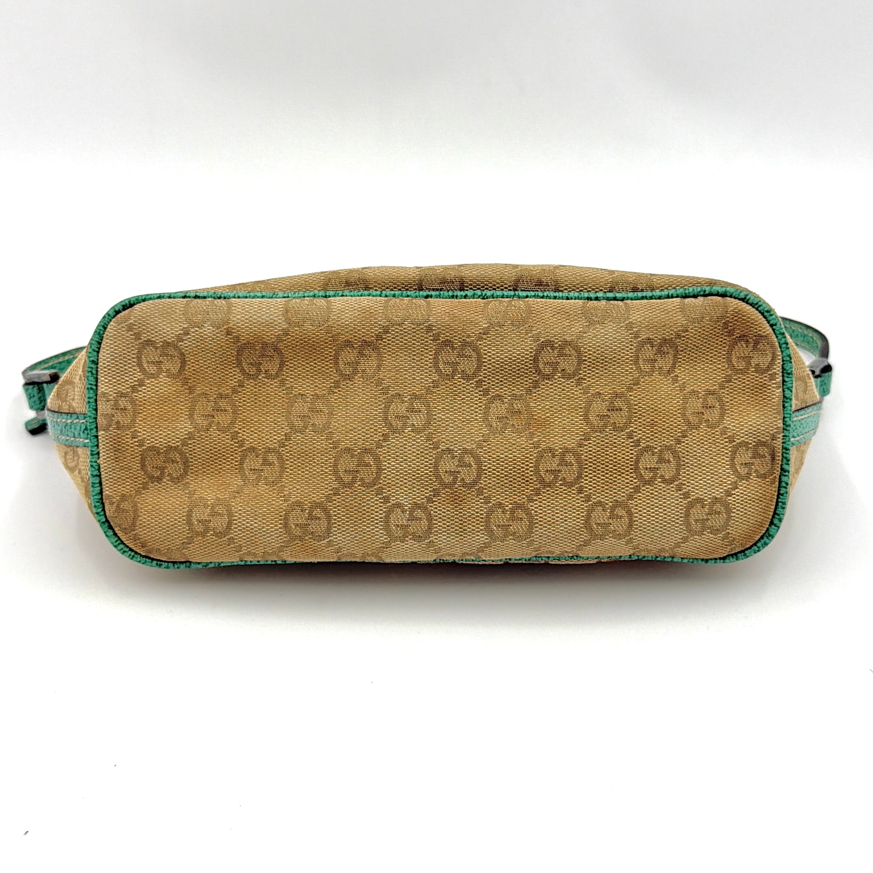 Gucci GG Monogram Pochette Boat Shoulder Bag in beige canvas with green leather trim and a structured, boat-shaped silhouette.