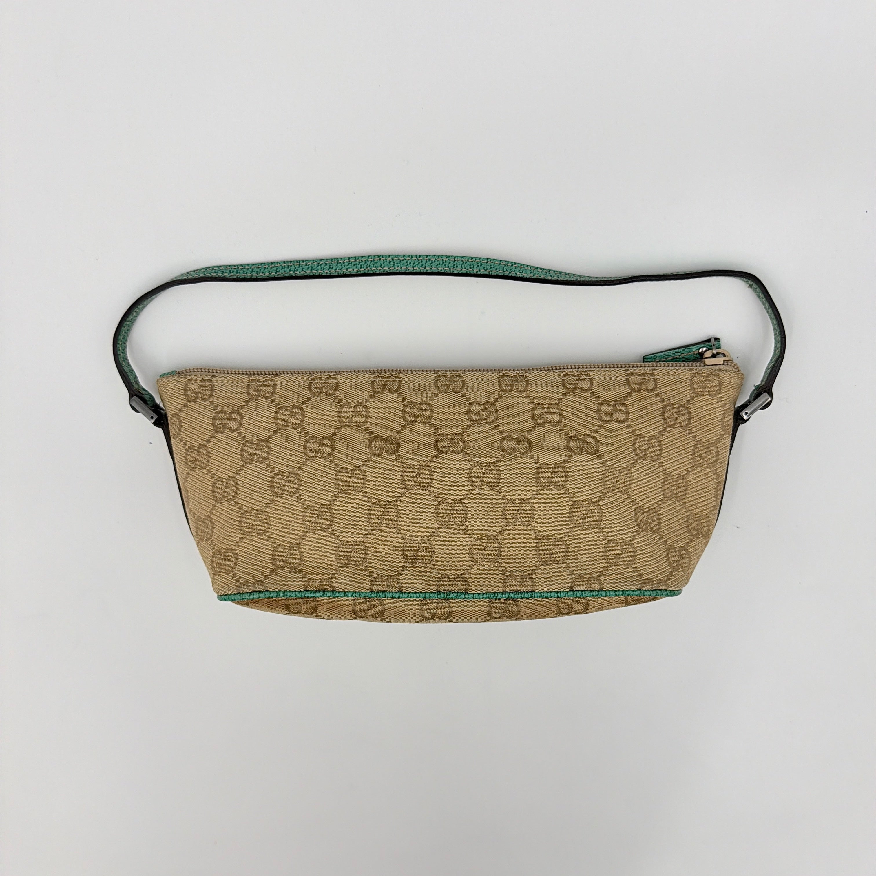 Gucci GG Monogram Pochette Boat Shoulder Bag in beige canvas with green leather trim and a structured, boat-shaped silhouette.