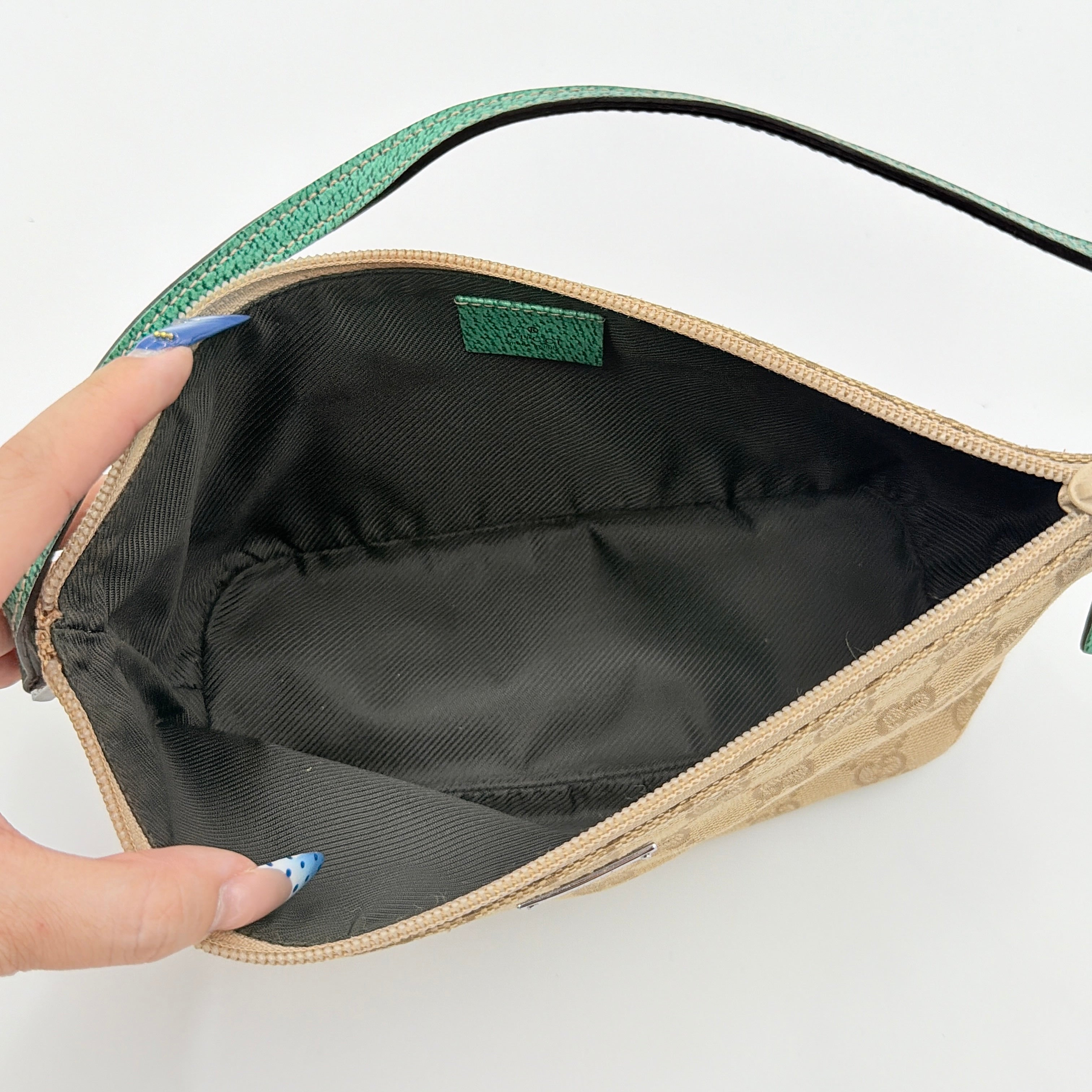 Gucci GG Monogram Pochette Boat Shoulder Bag in beige canvas with green leather trim and a structured, boat-shaped silhouette.